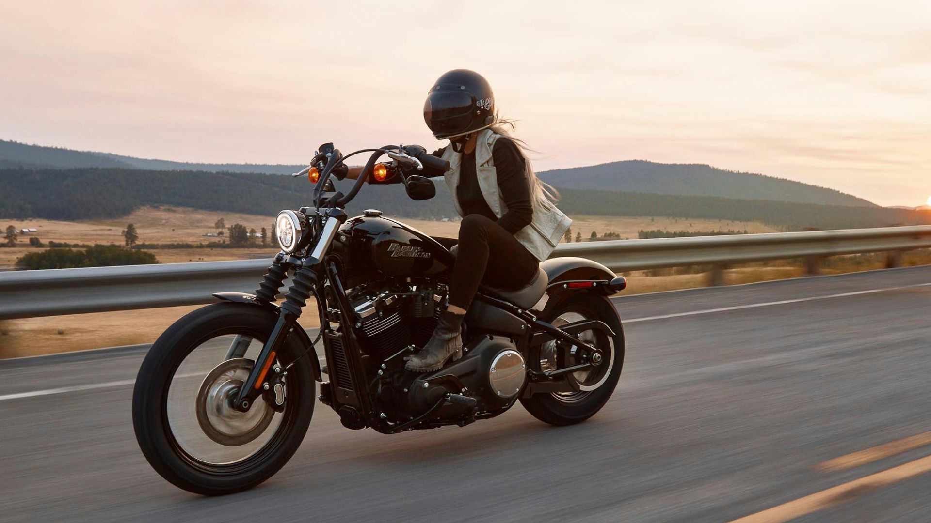 man on black cruiser motorcycle in highway