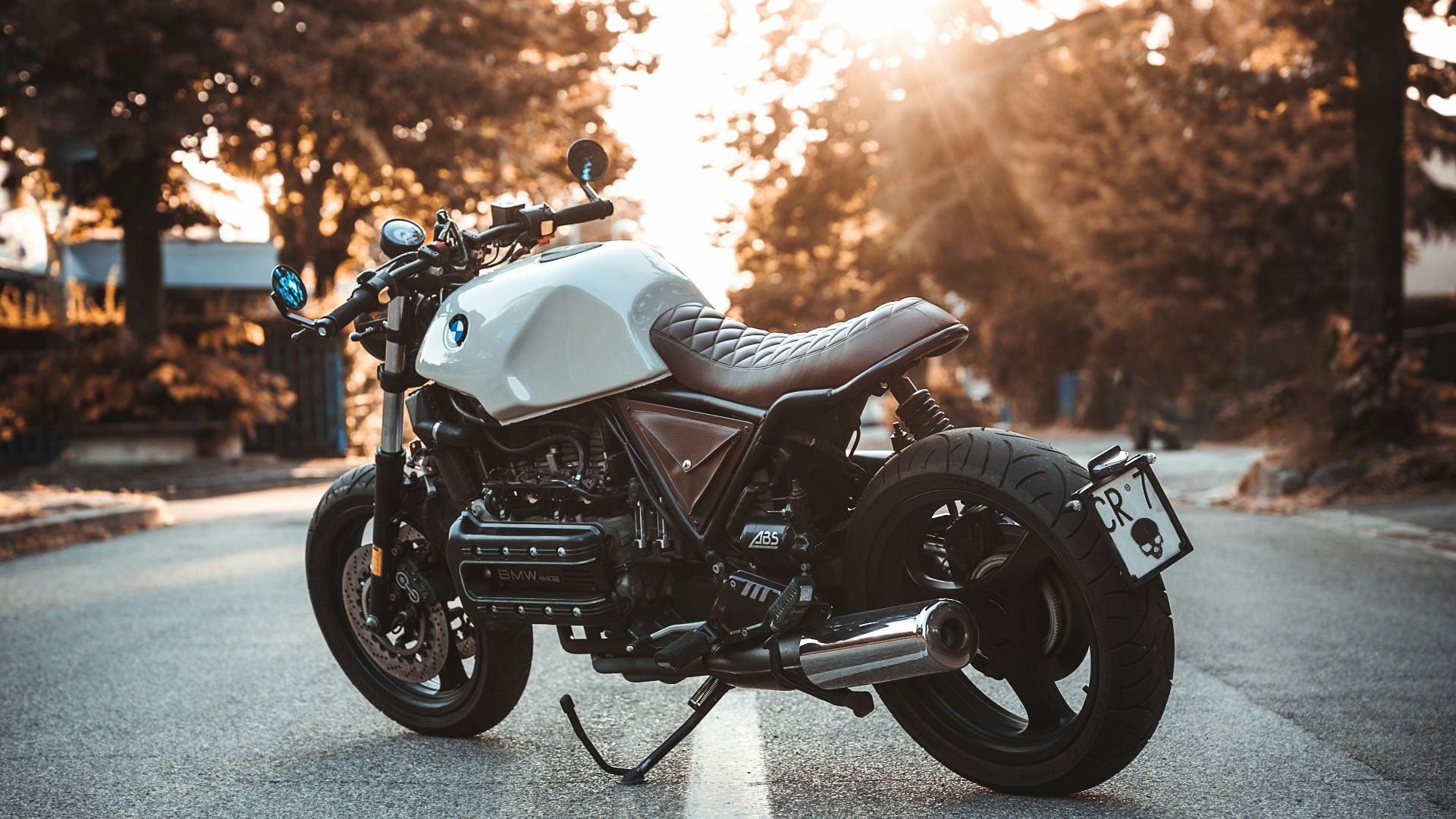 white and black BMW cruiser motorcycle in the center of road