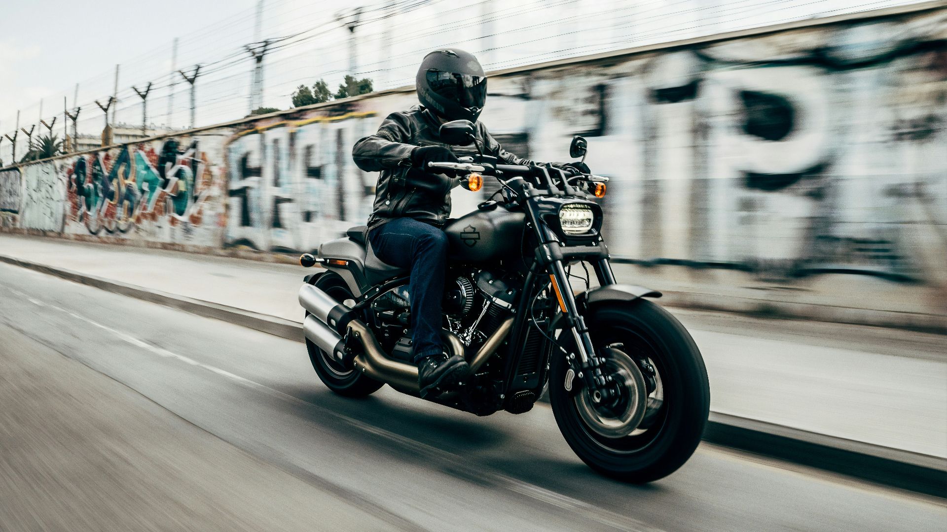 person riding motorcycle on concrete road
