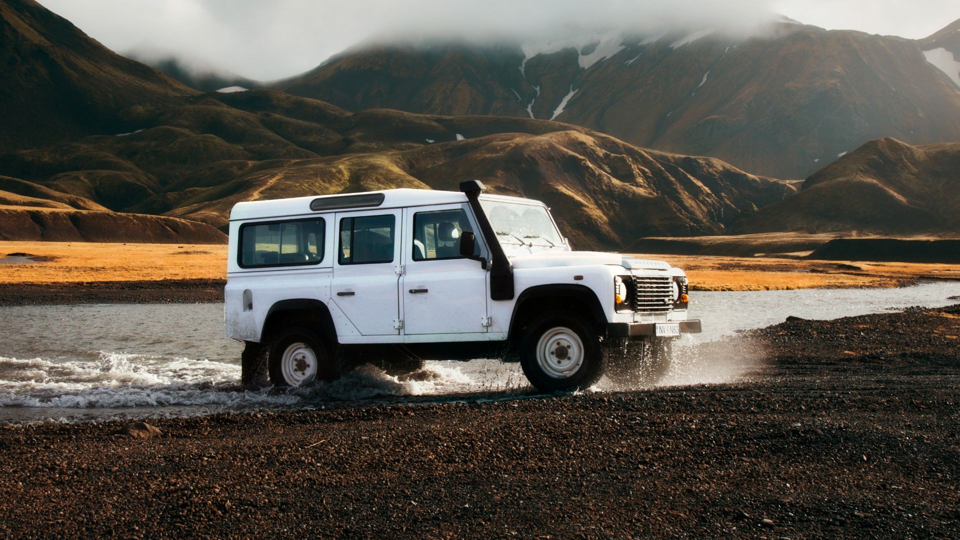white car crossing body of water