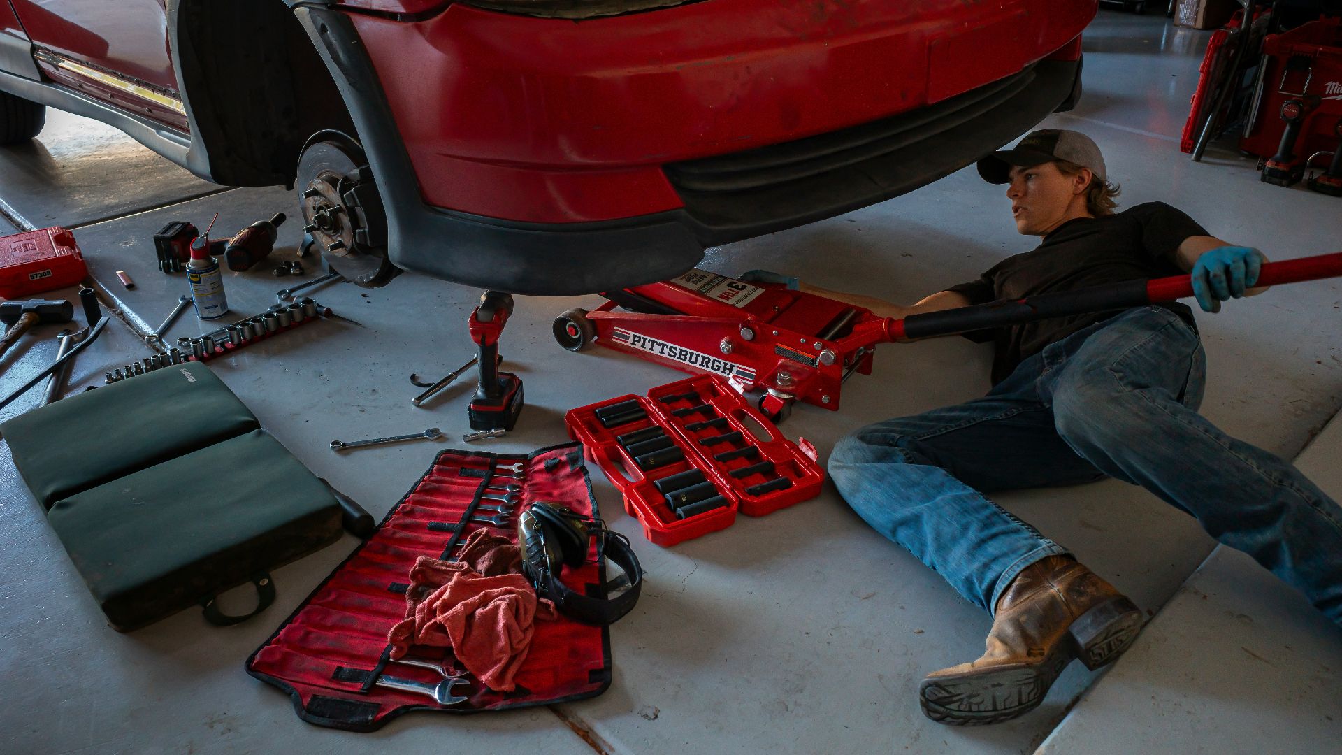 a man working on a car in a garage