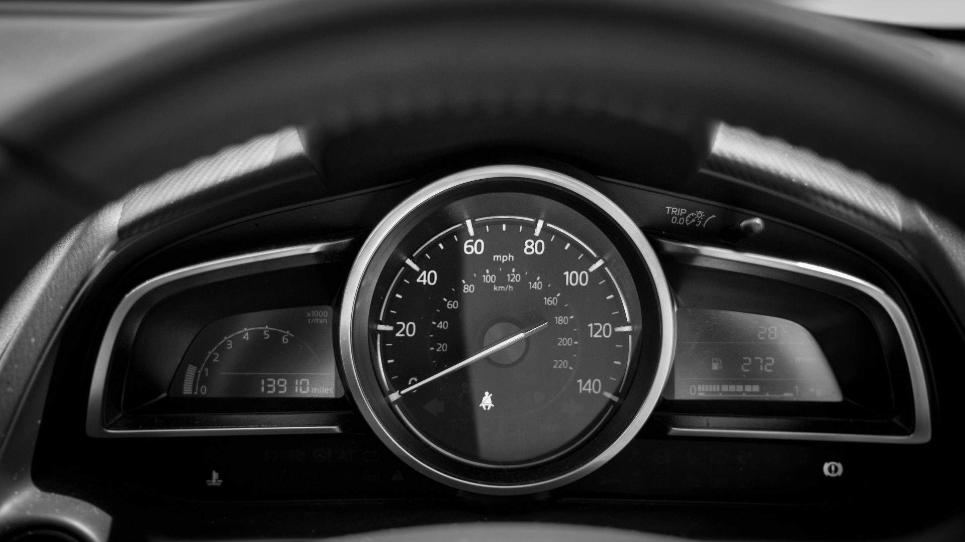 black and white car speedometer