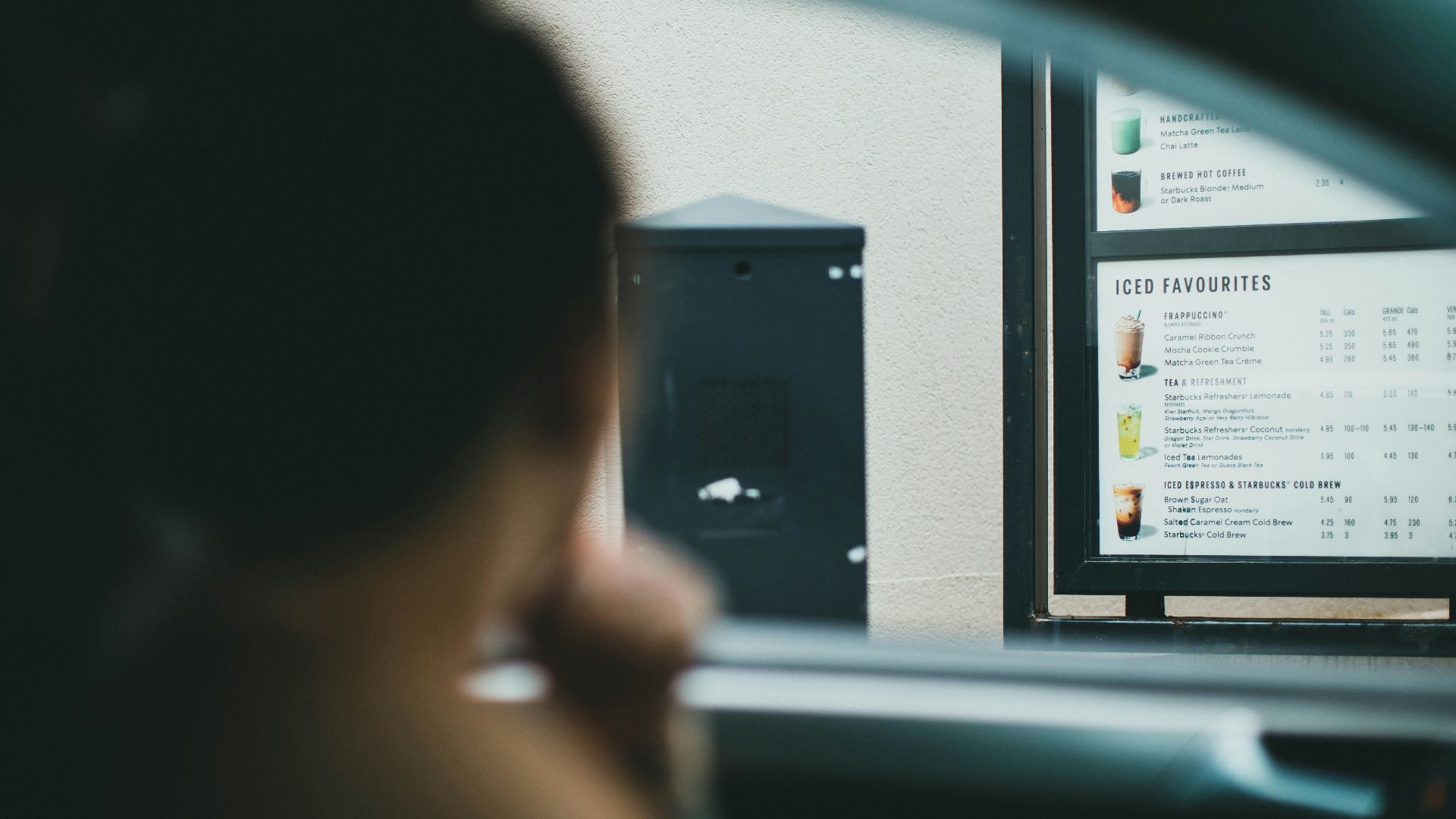 person holding black smartphone in car