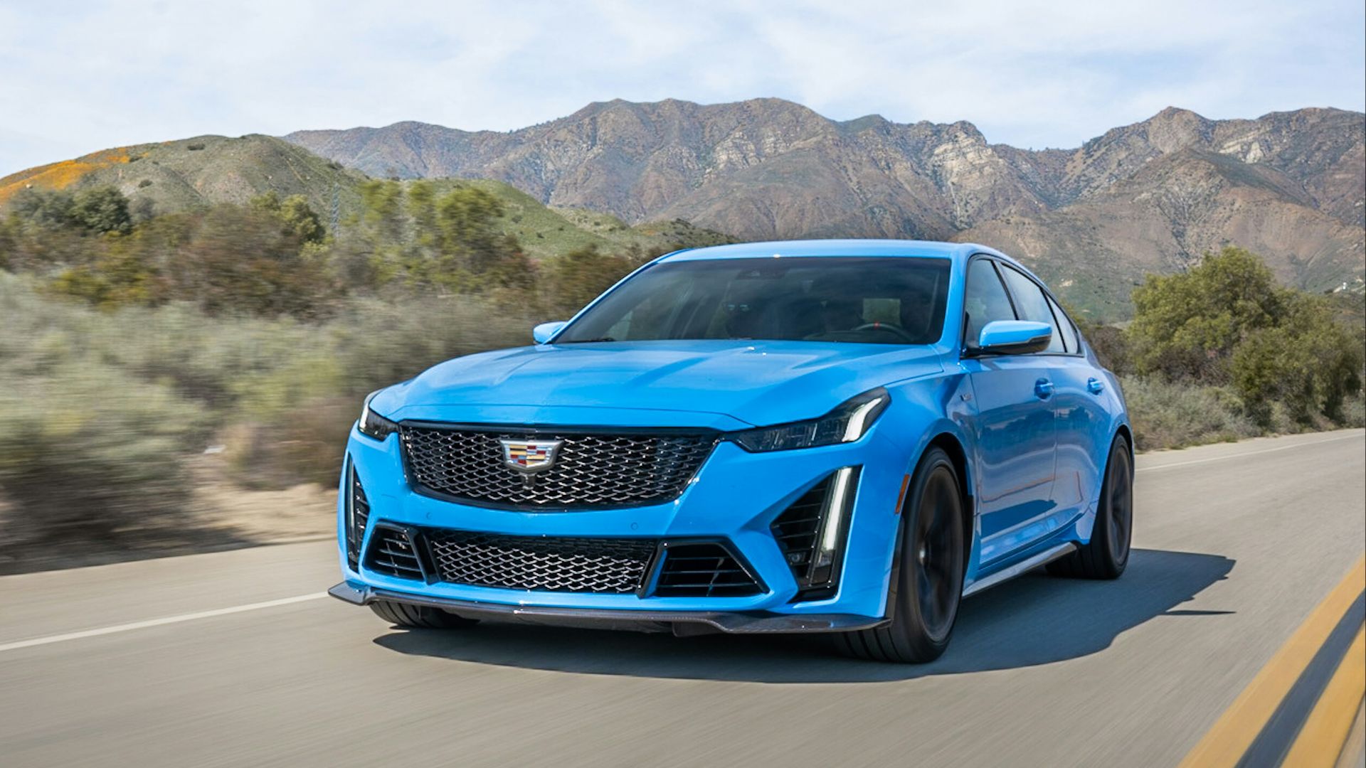 a blue car on a road