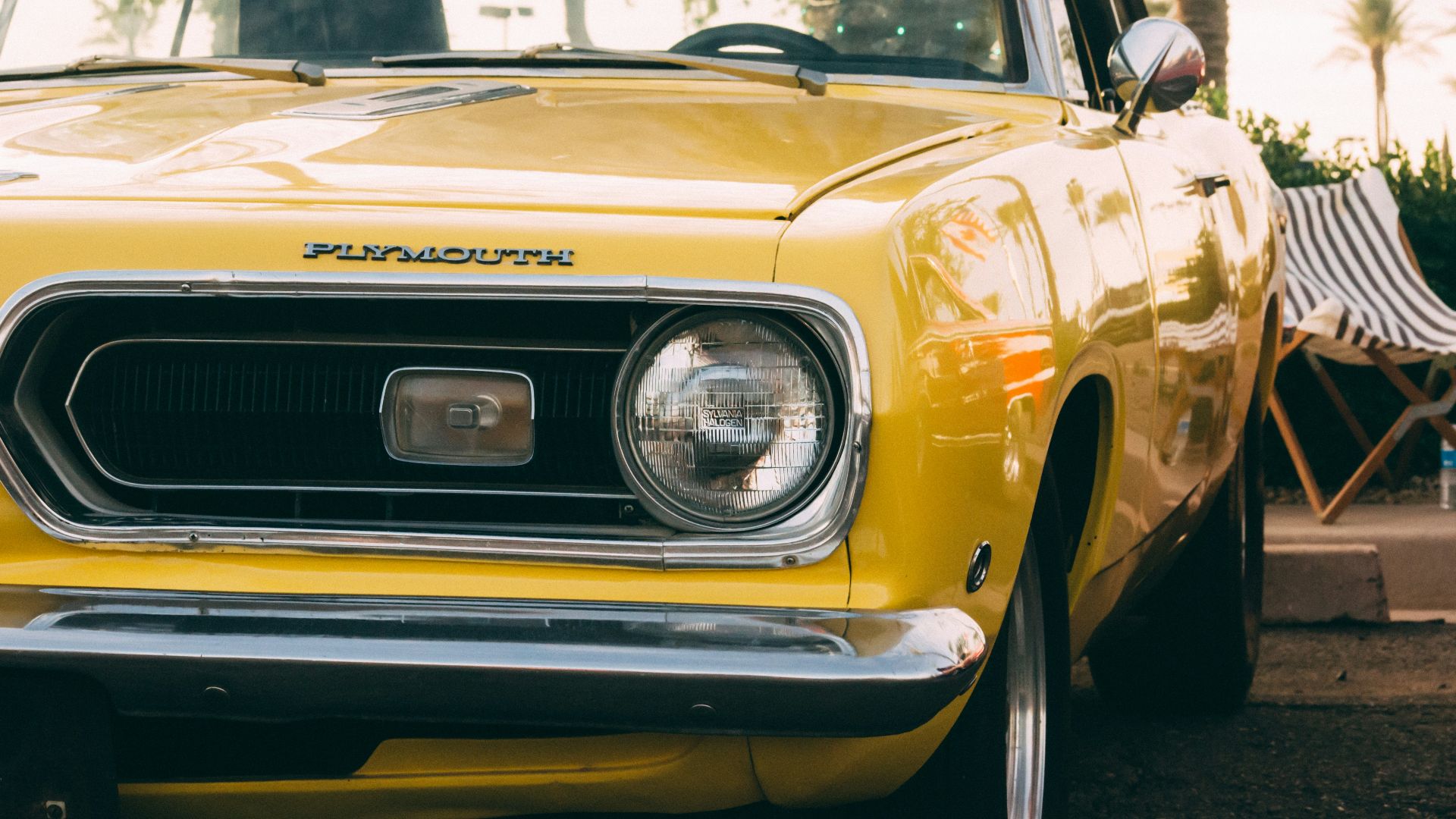 yellow vehicle parked beside deckchair