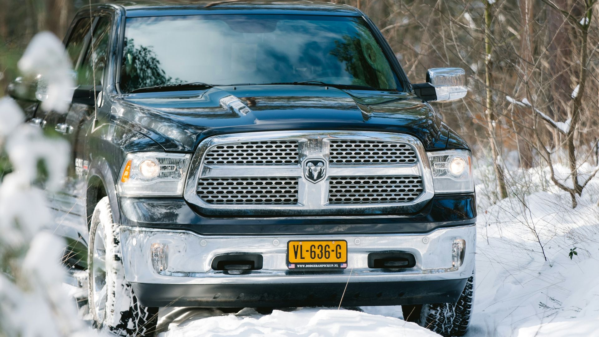 black chevrolet car on snow covered ground during daytime