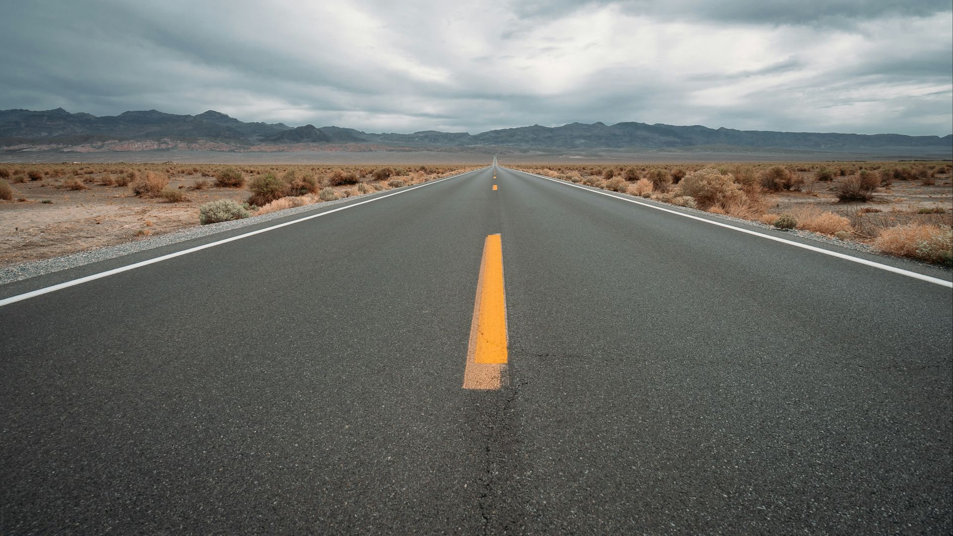 black asphalt road under cloudy sky during daytime