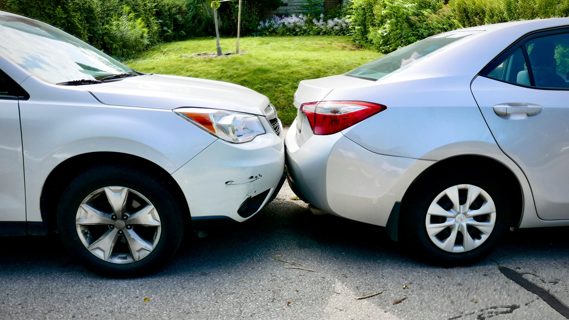 a couple of white cars parked next to each other