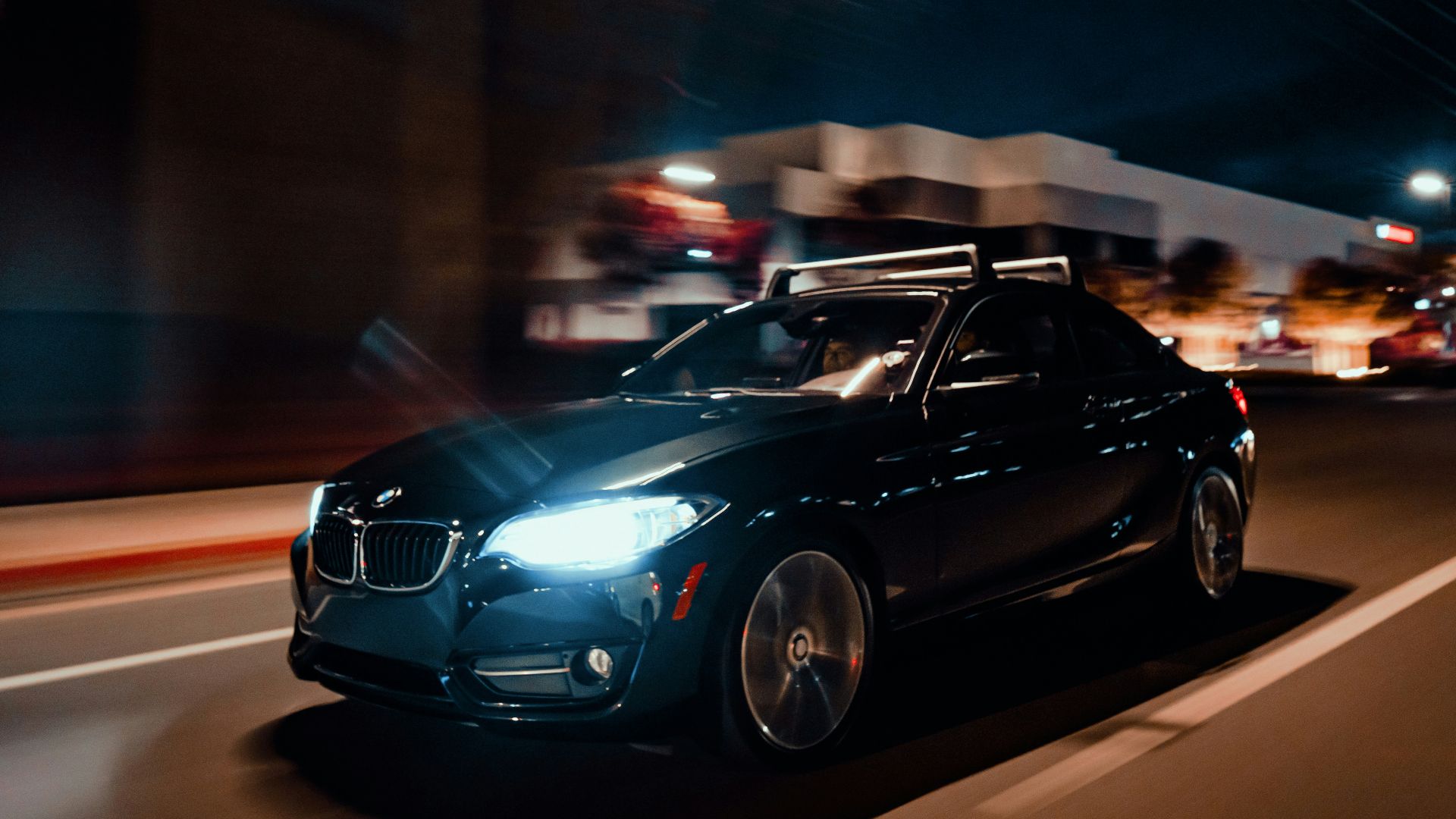 a car driving down a street at night