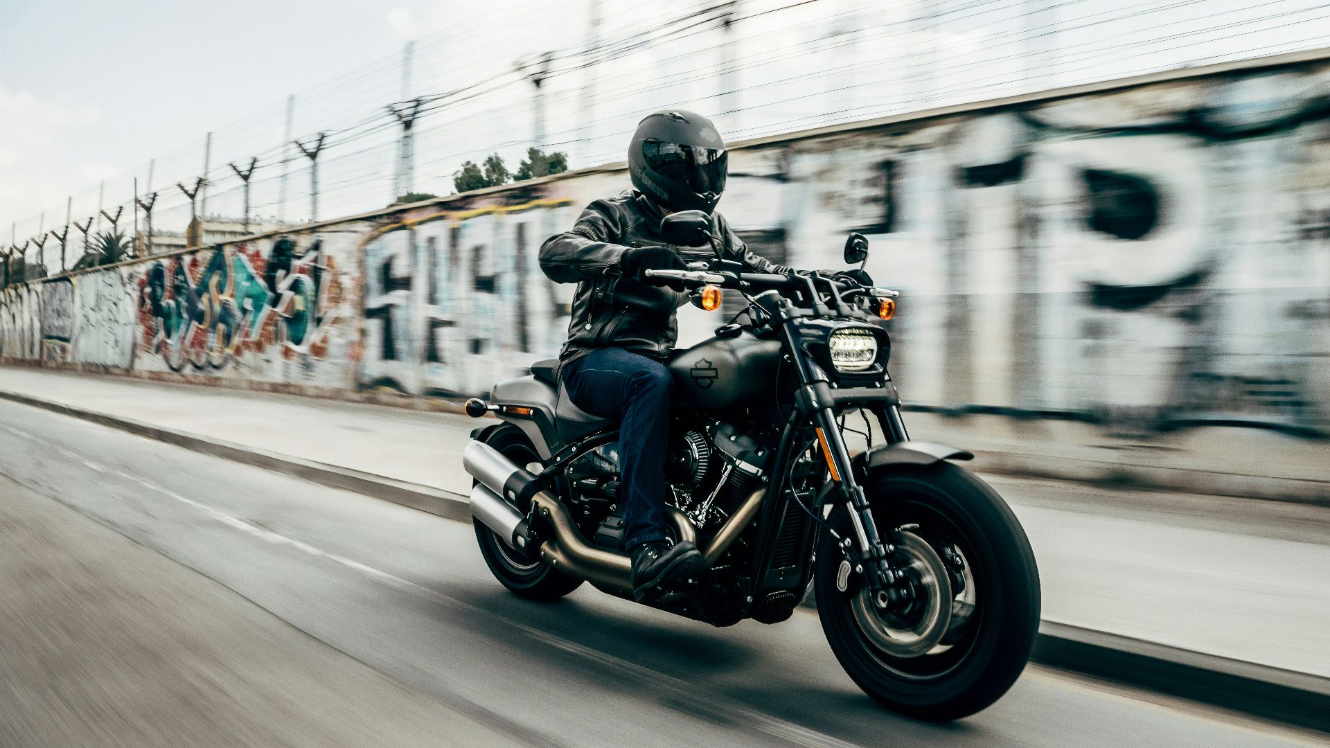 person riding motorcycle on concrete road