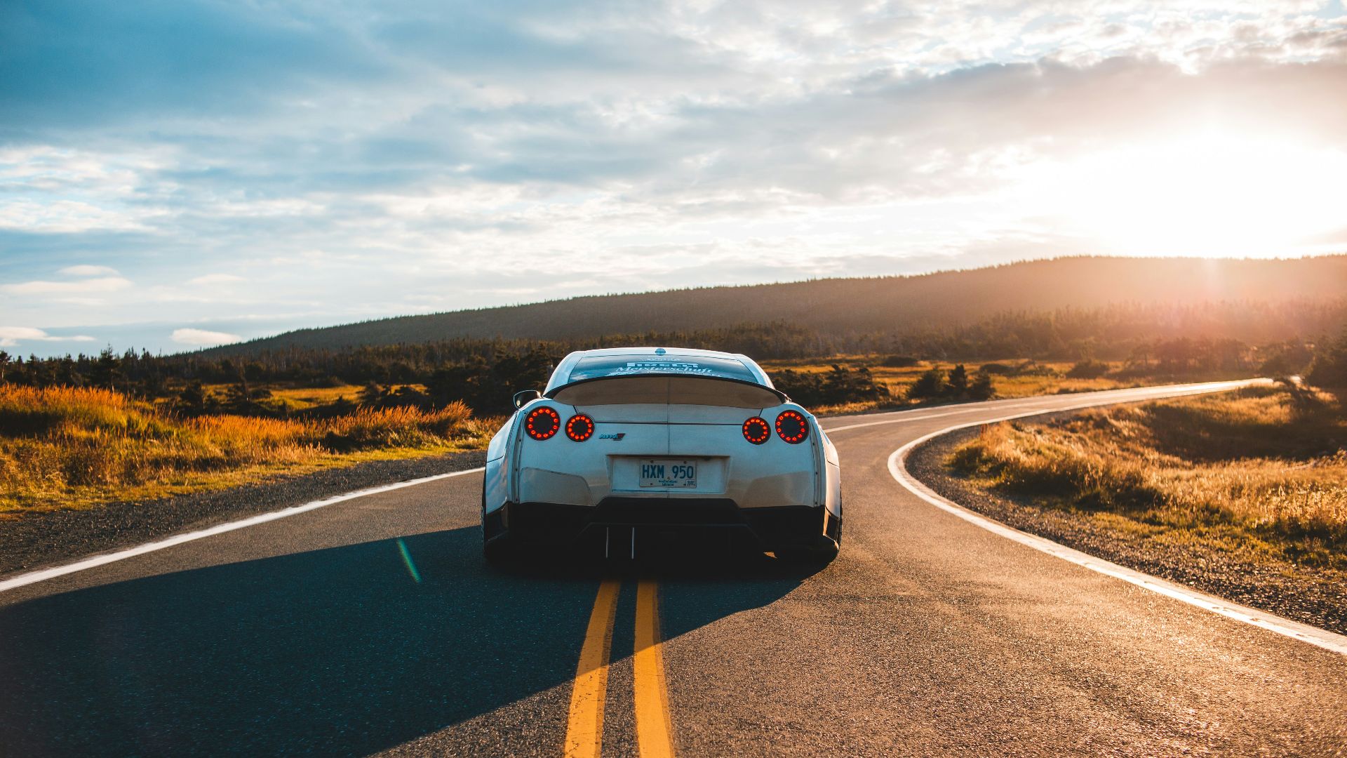 silver sports coupe on asphalt road