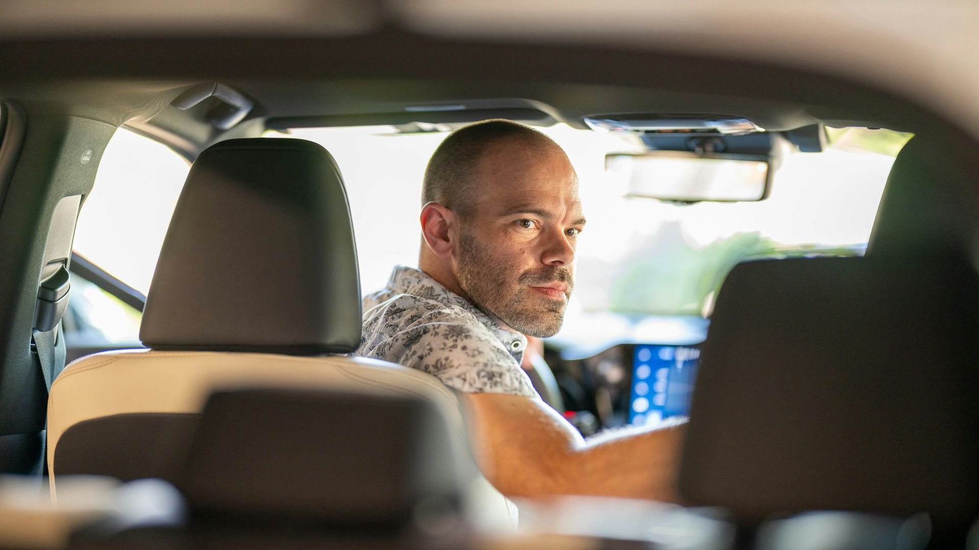 a man sitting in the passenger seat of a car