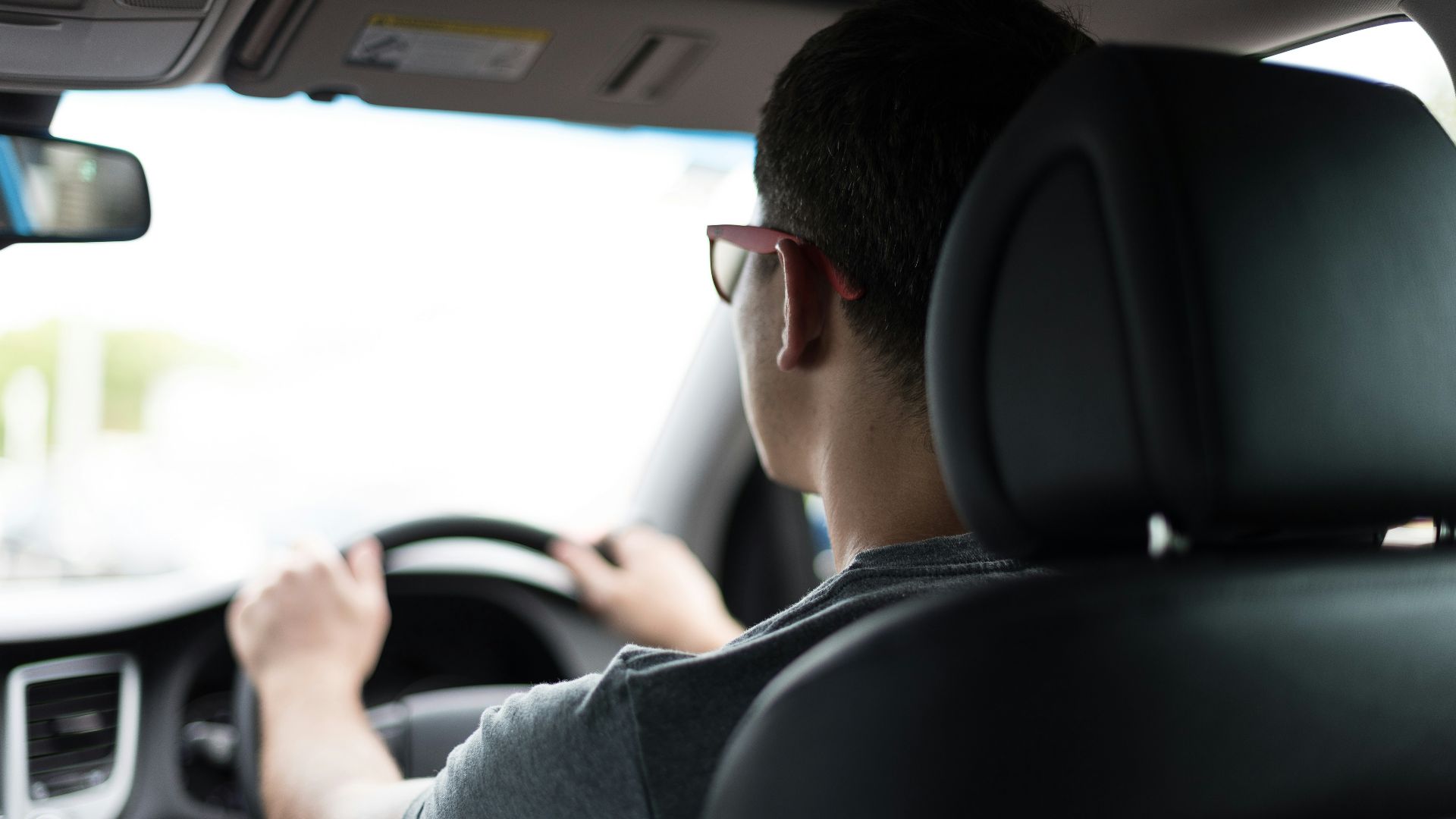 man driving car during daytime