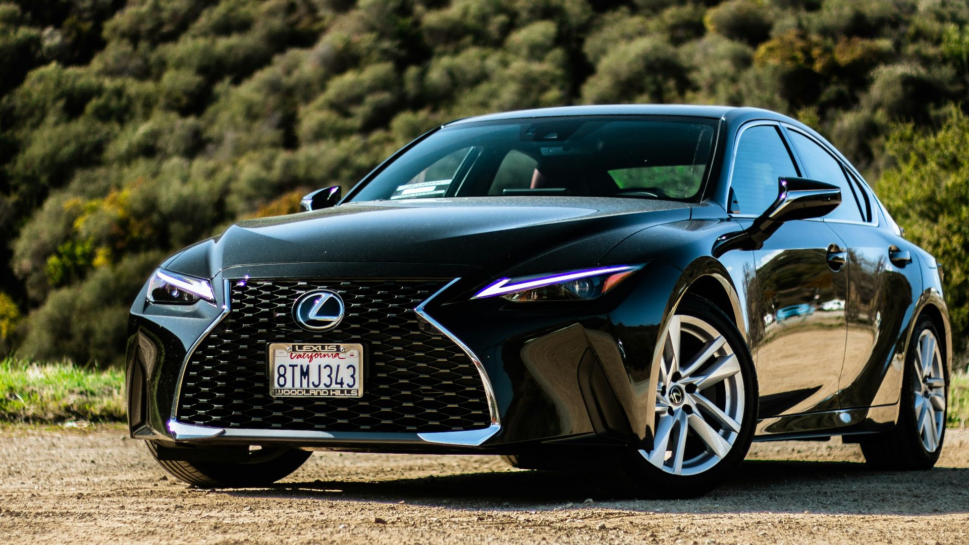 black porsche 911 on brown field during daytime