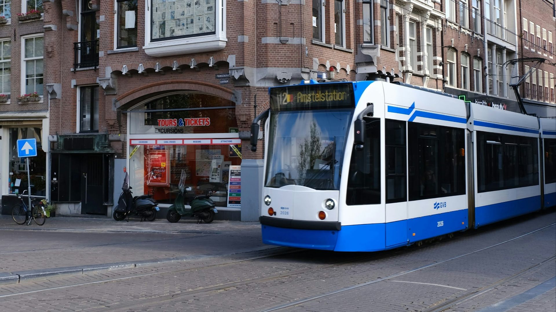 white and blue train on the street during daytime
