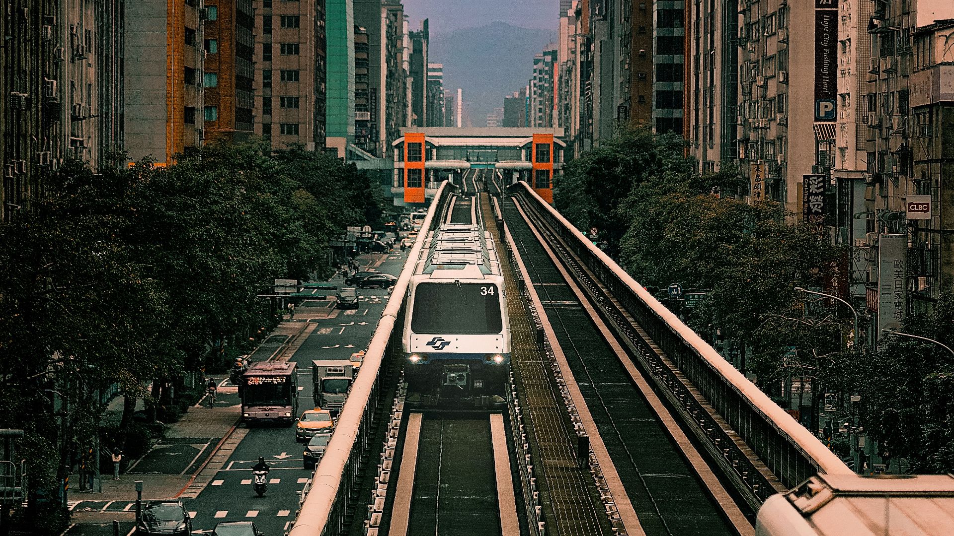 a train traveling down train tracks next to tall buildings