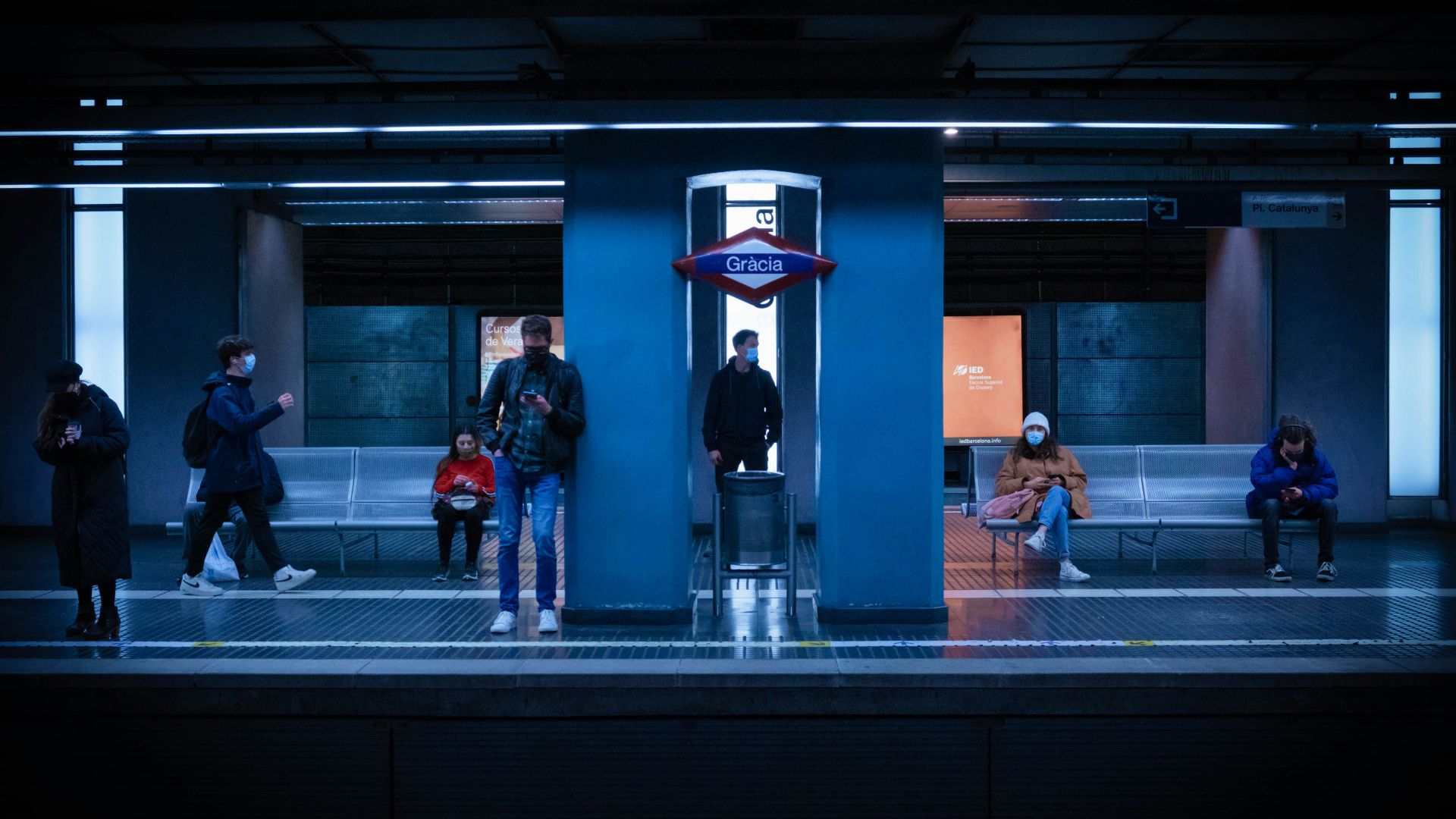 2 men standing in front of red and black building