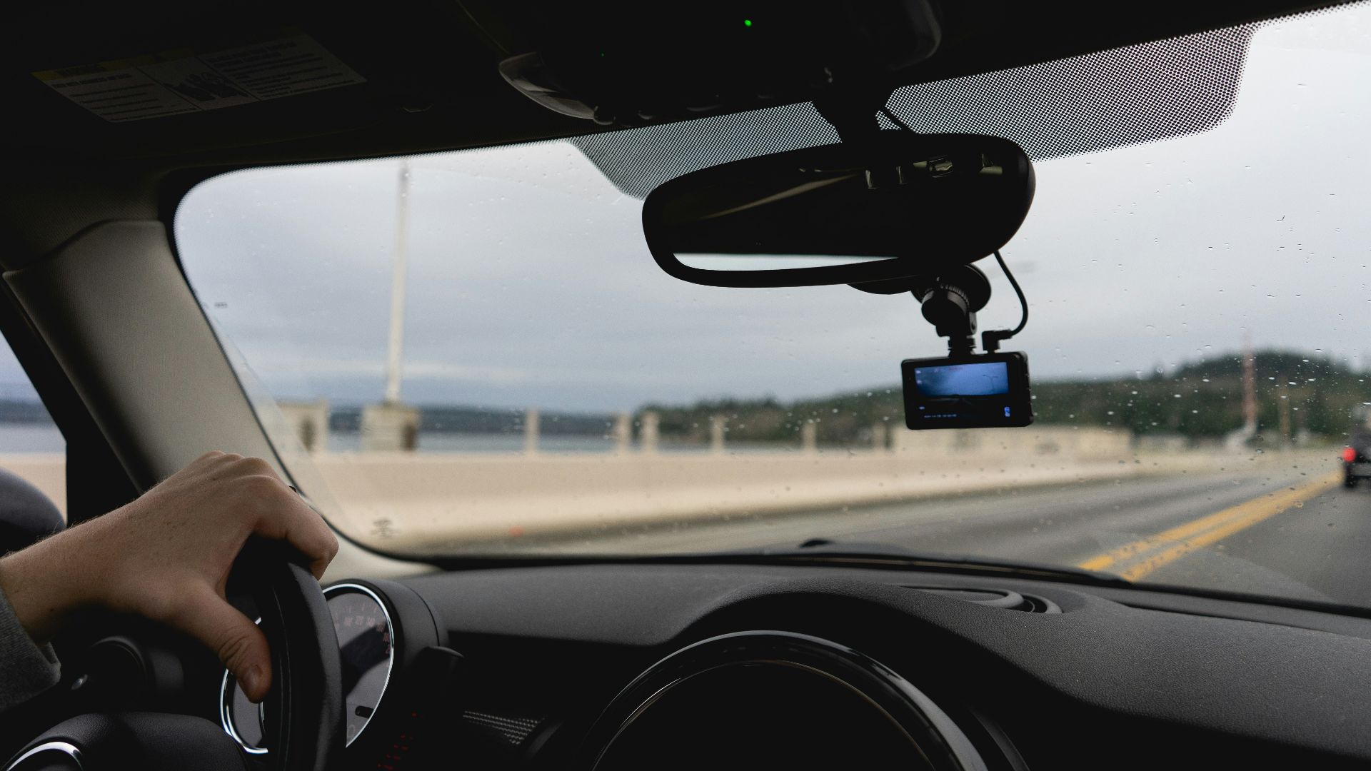 a person driving a car on a highway