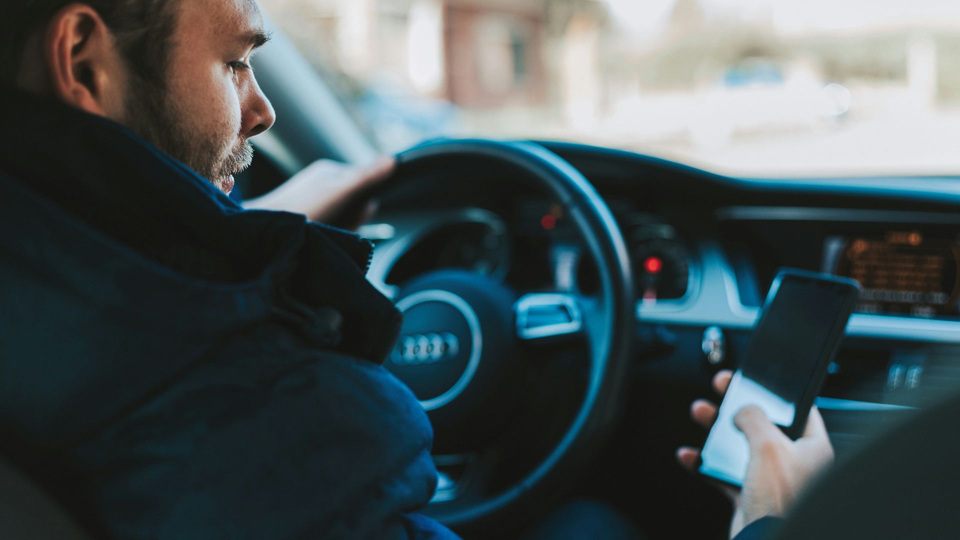 man holding black smartphone