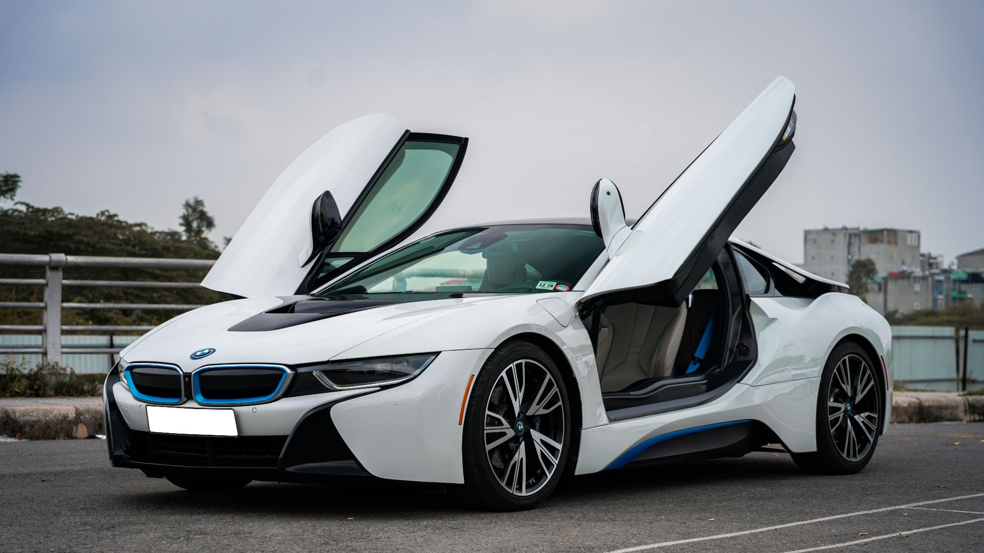 a white sports car with doors open