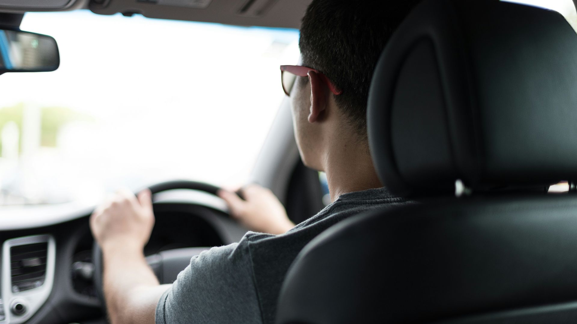 man driving car during daytime