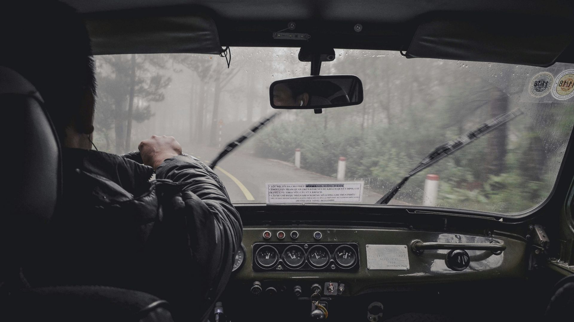 man driving car during rainy daytime