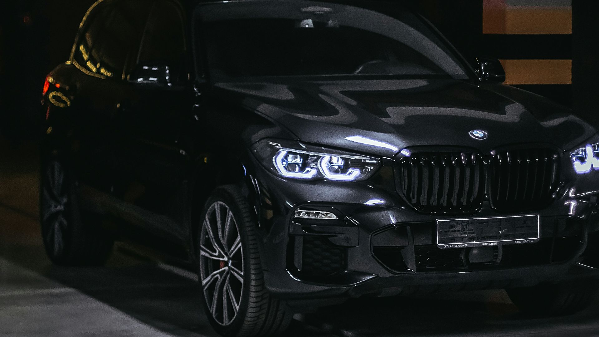 a black car parked in a parking garage