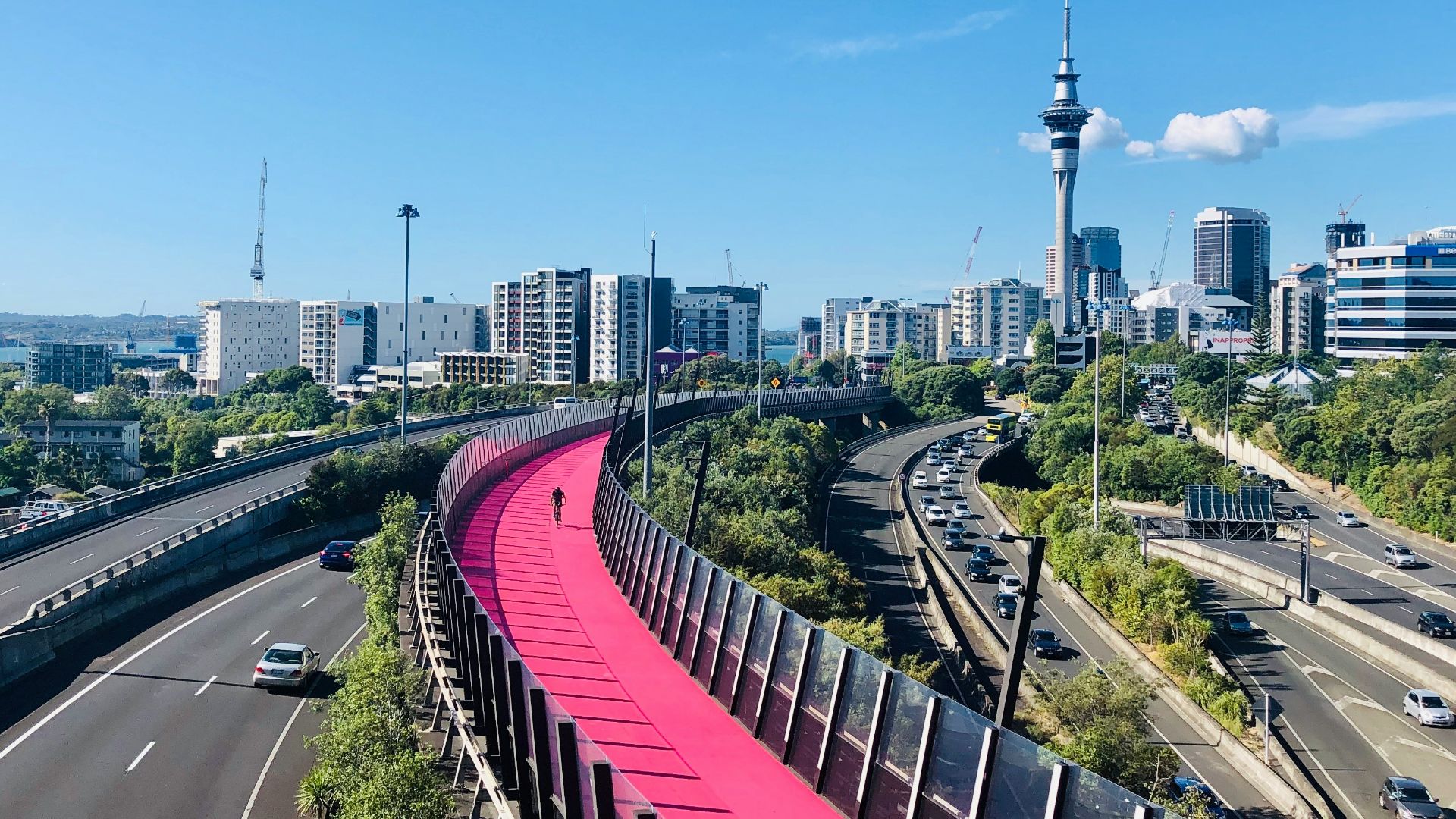 red metal fence near city buildings during daytime