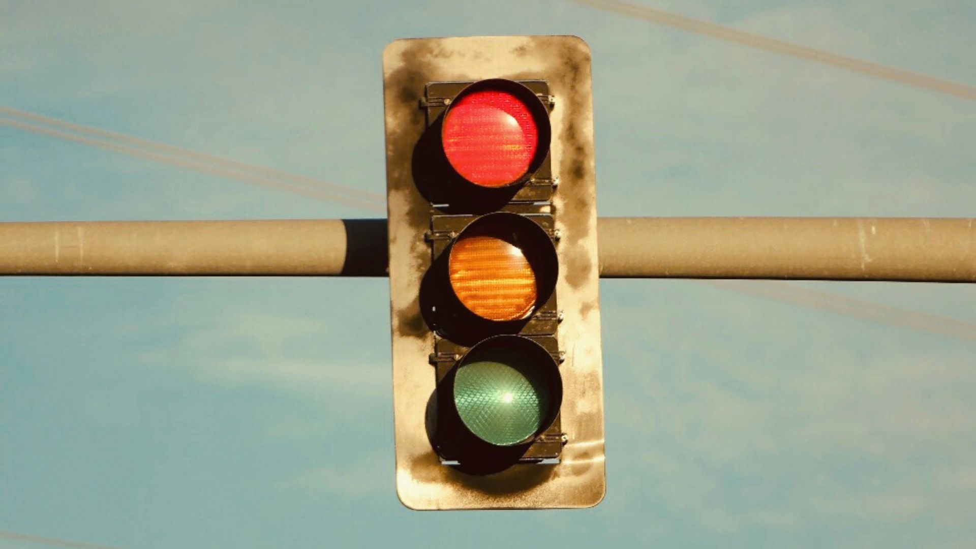 a traffic light hanging from a metal pole