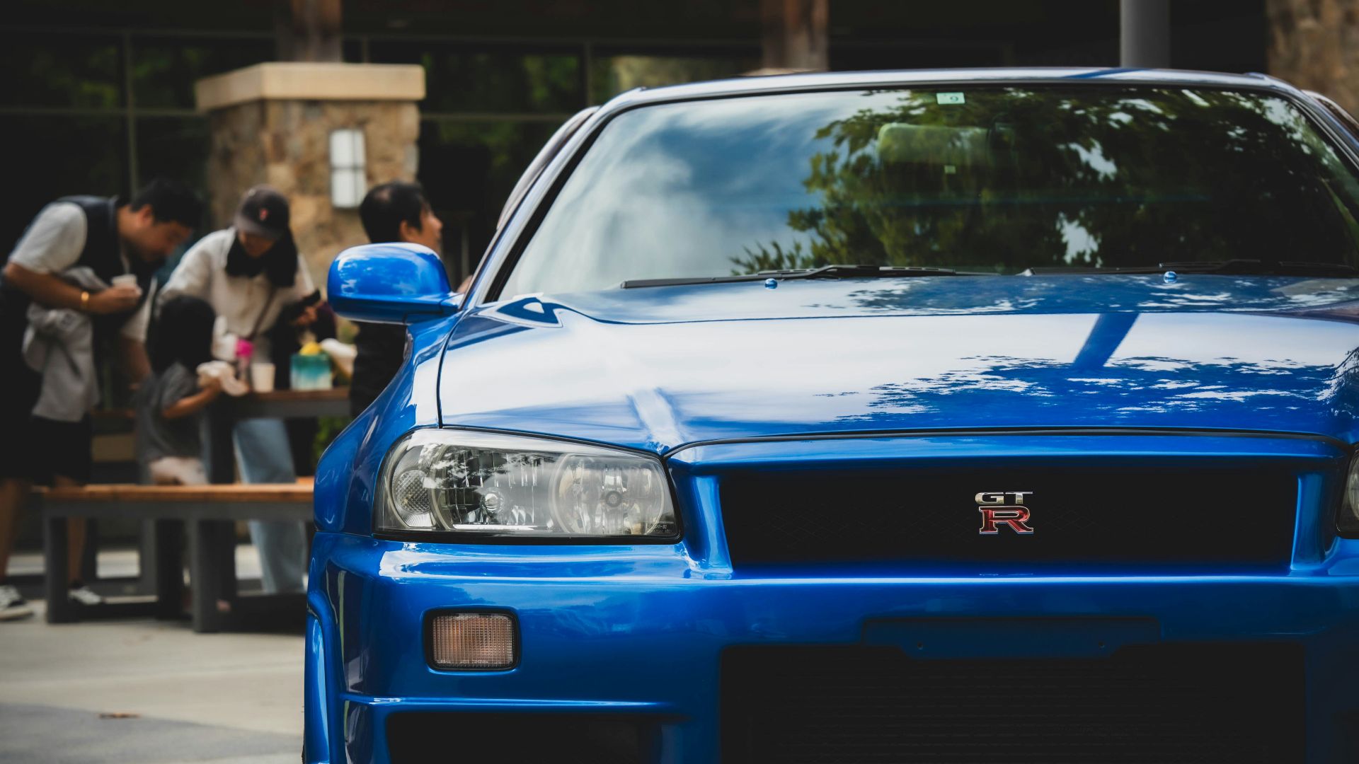 Blue sports car parked outside a building