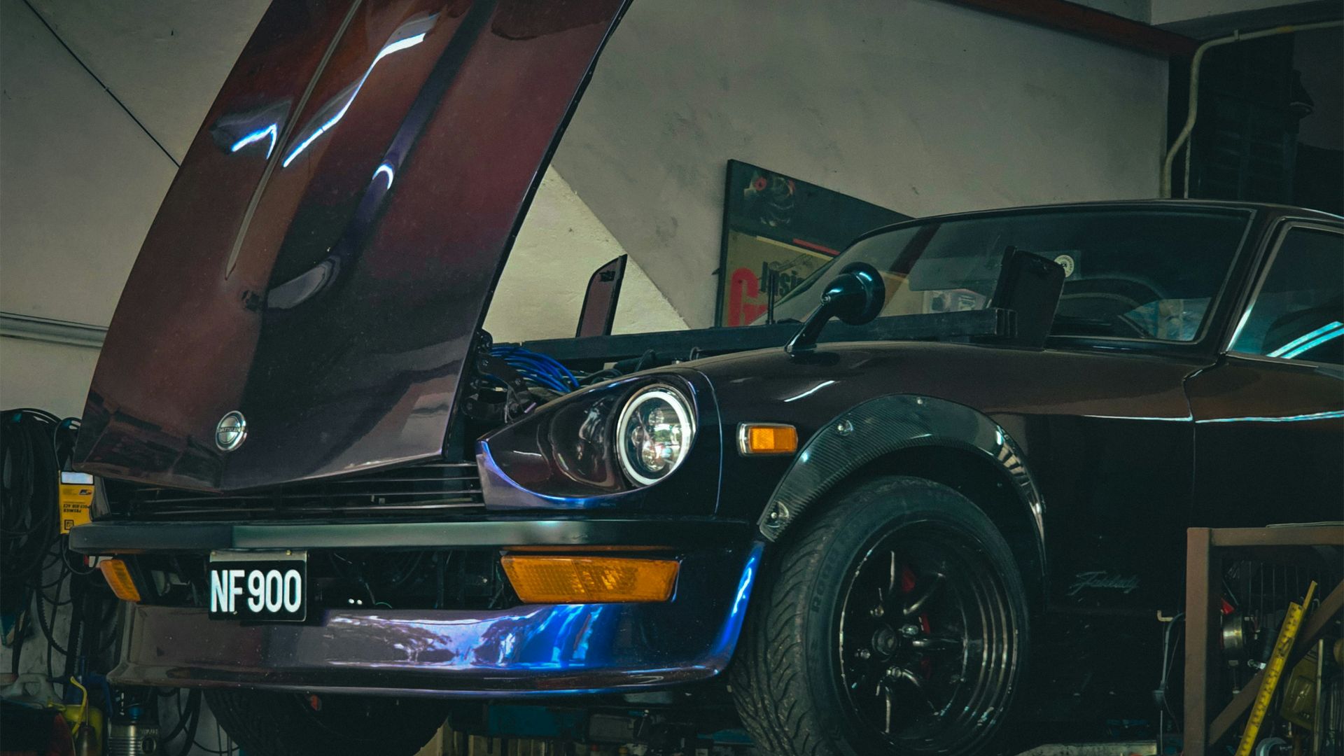 A car in a garage with the hood open