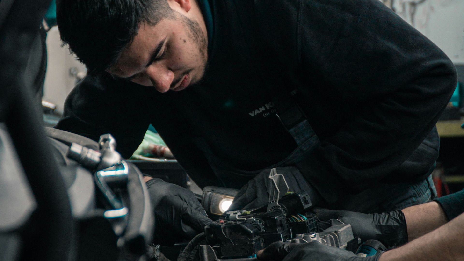 man in black jacket and blue denim jeans riding motorcycle