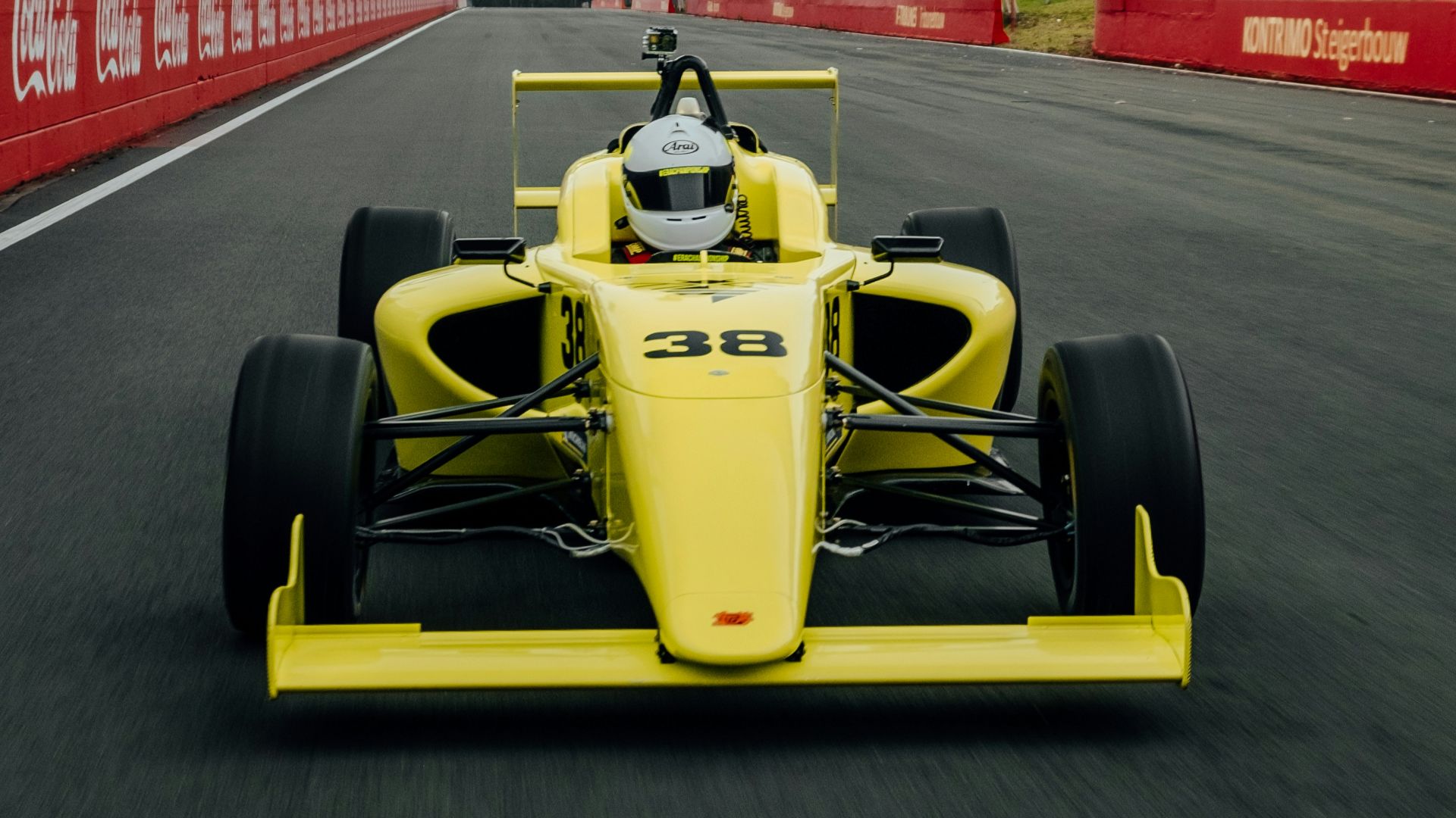 yellow and black f 1 car on road during daytime