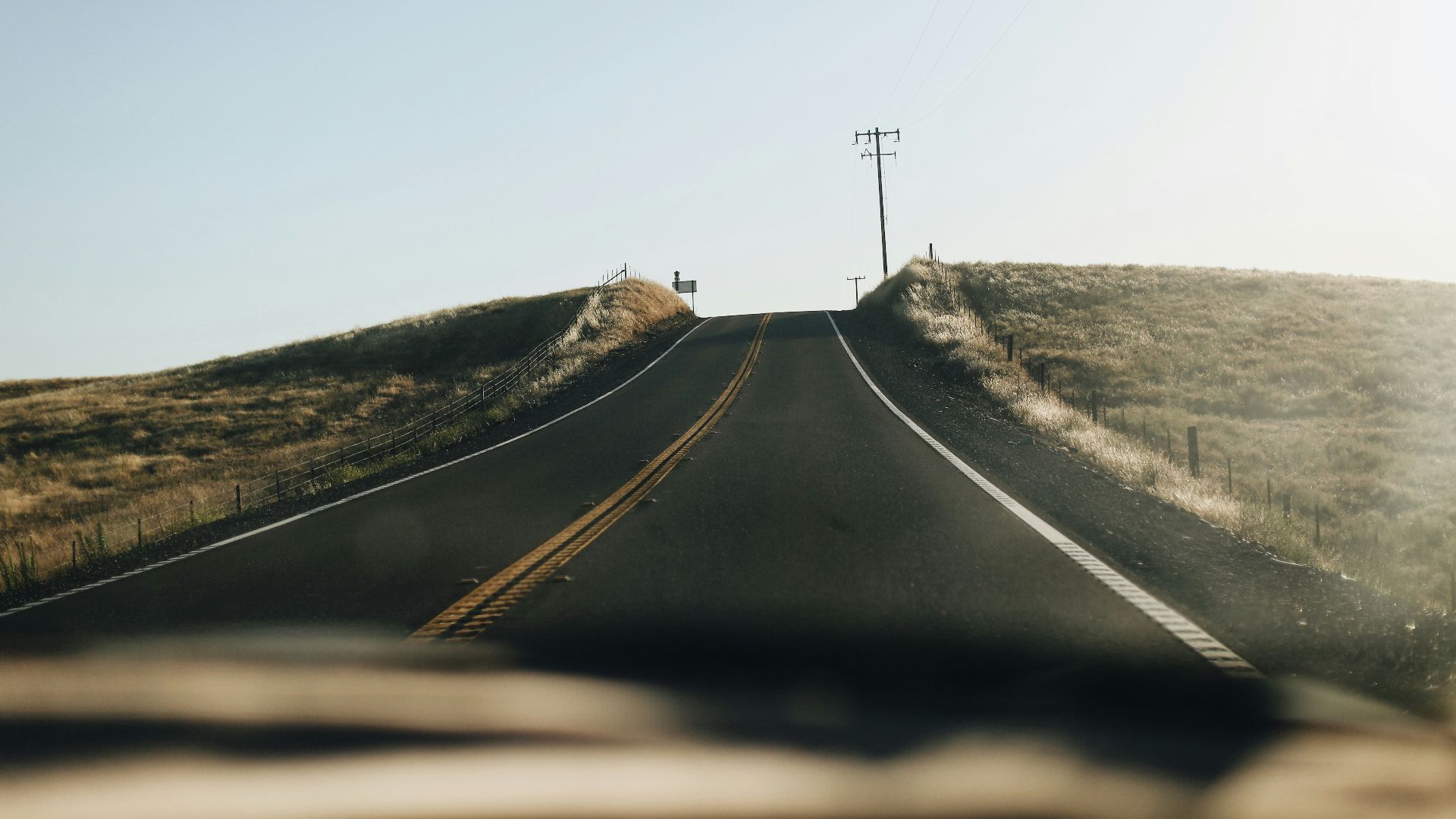 black asphalt road under blue sky during daytime