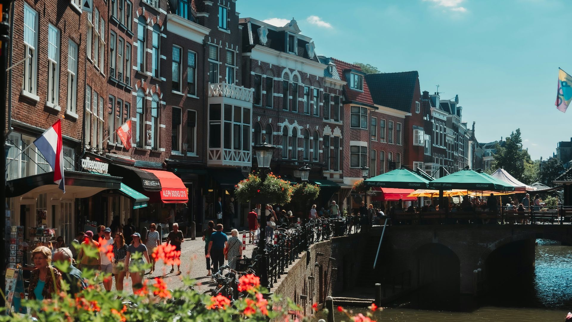 a group of people walking on a bridge over a river