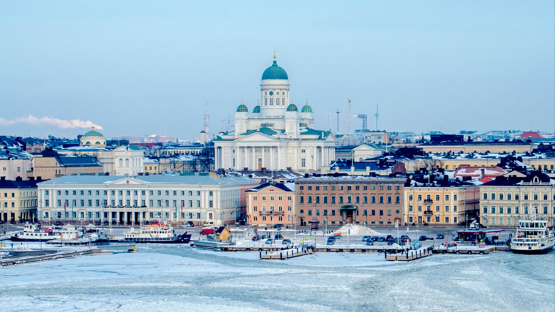 white and blue mosque among buildings