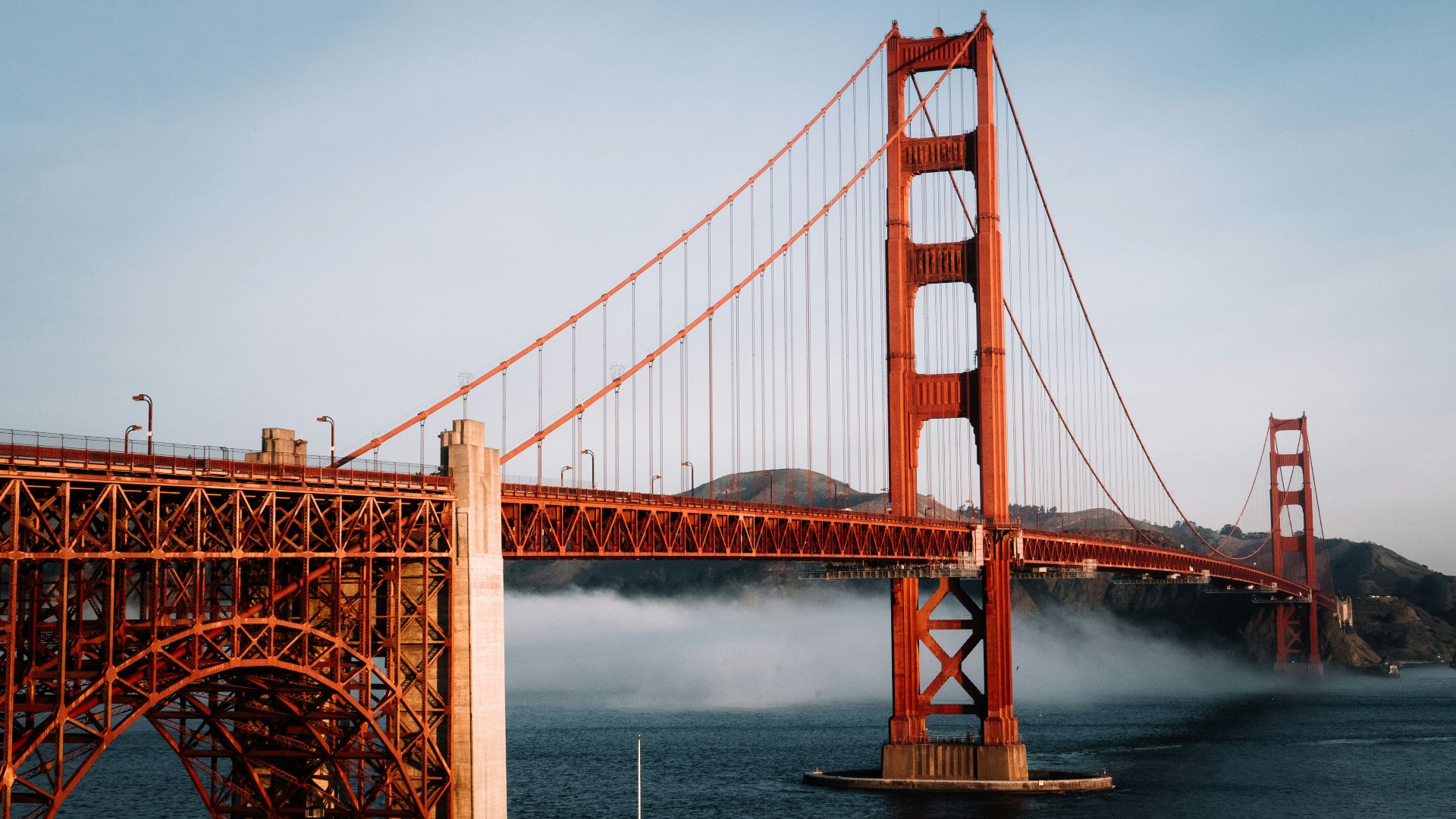 The golden gate bridge is surrounded by fog