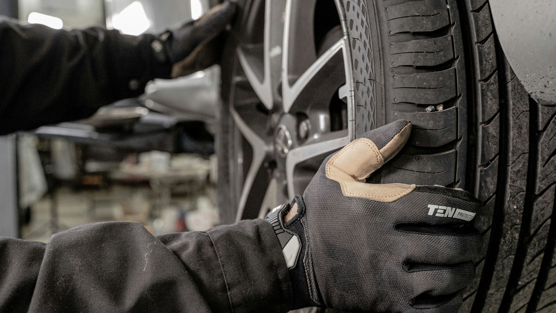a man working on a tire in a garage
