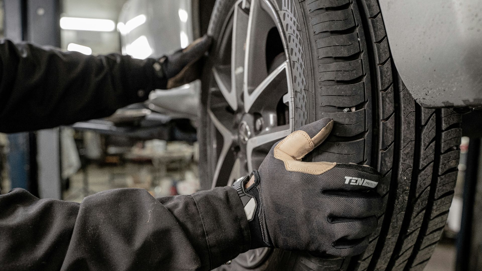 a man working on a tire in a garage