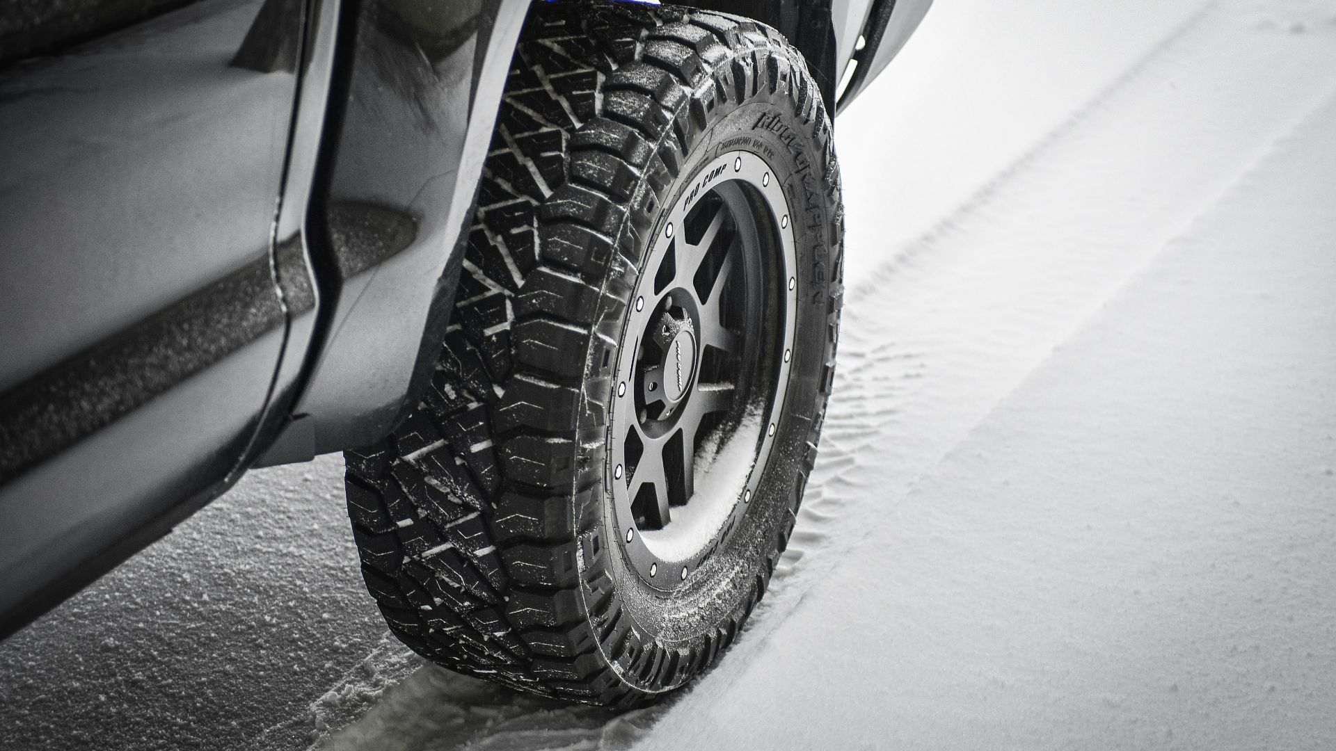 grayscale photo of car wheel