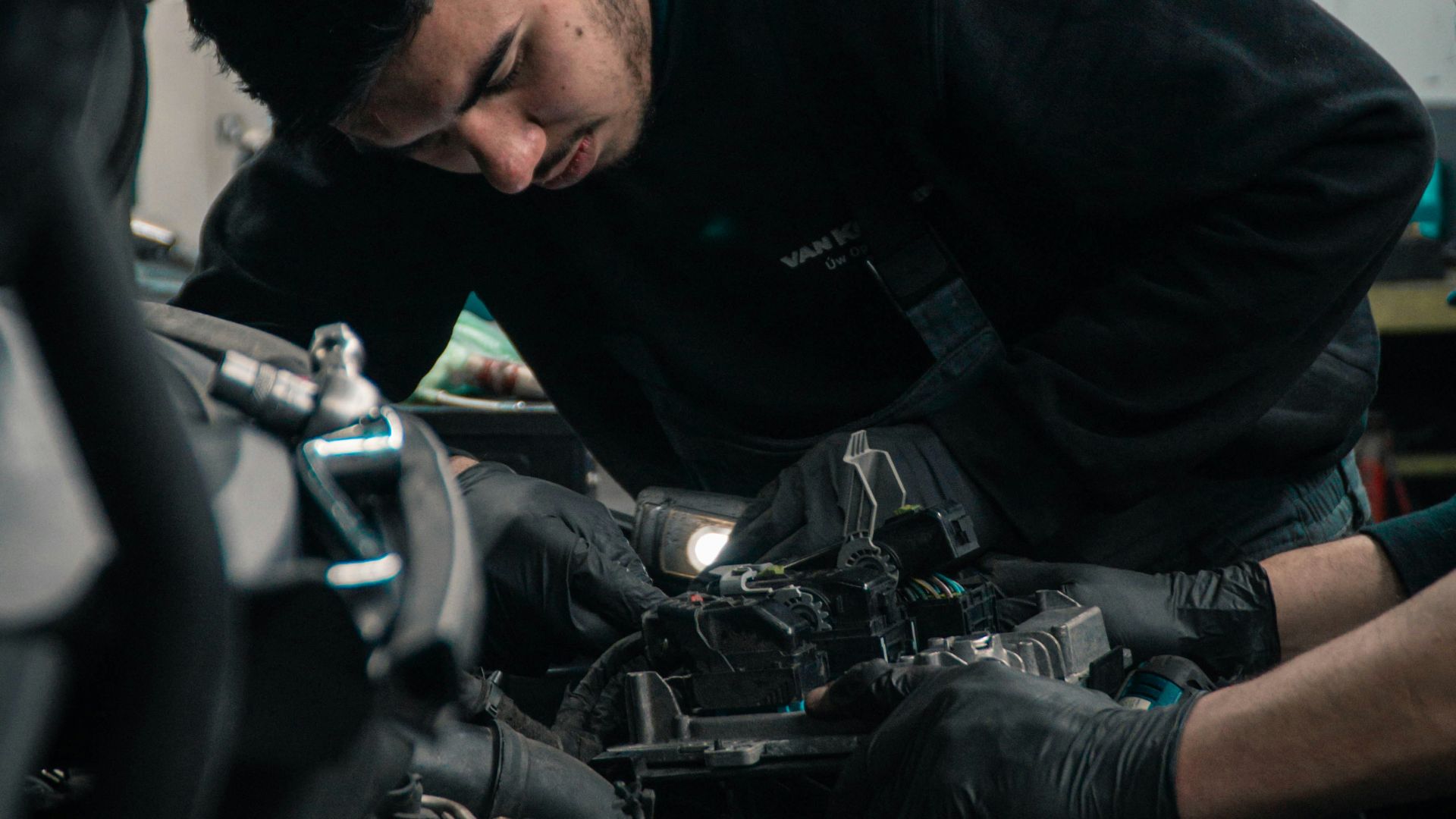 man in black jacket and blue denim jeans riding motorcycle