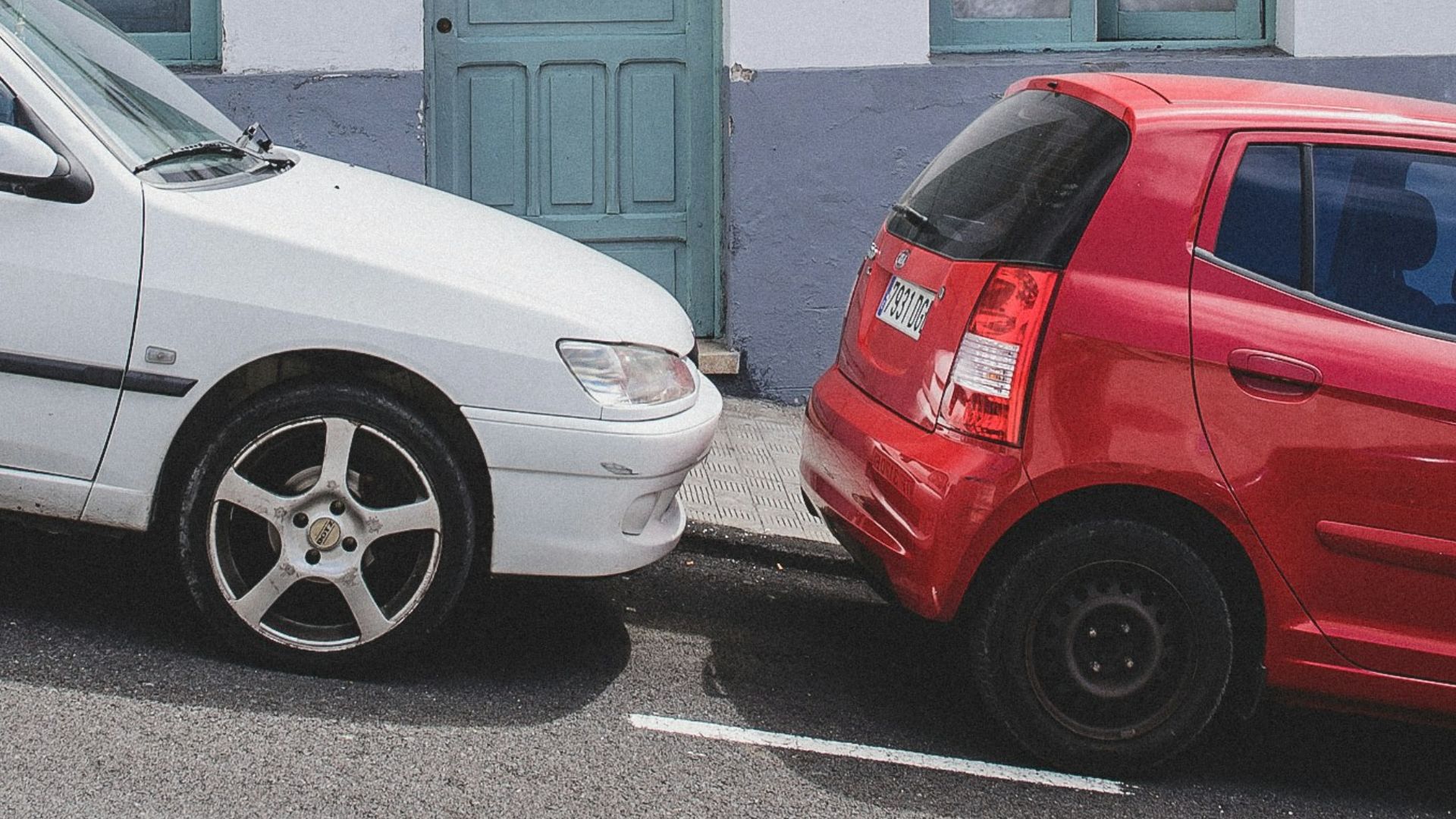 white and red 5-door hatchbacks on street