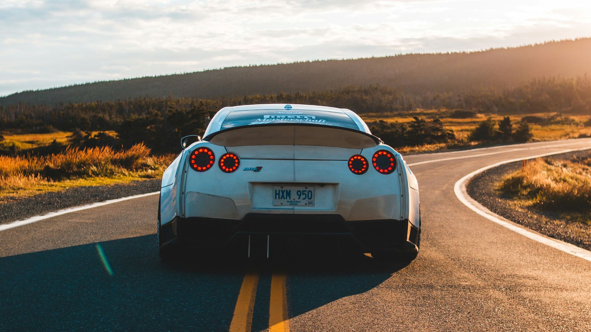 silver sports coupe on asphalt road