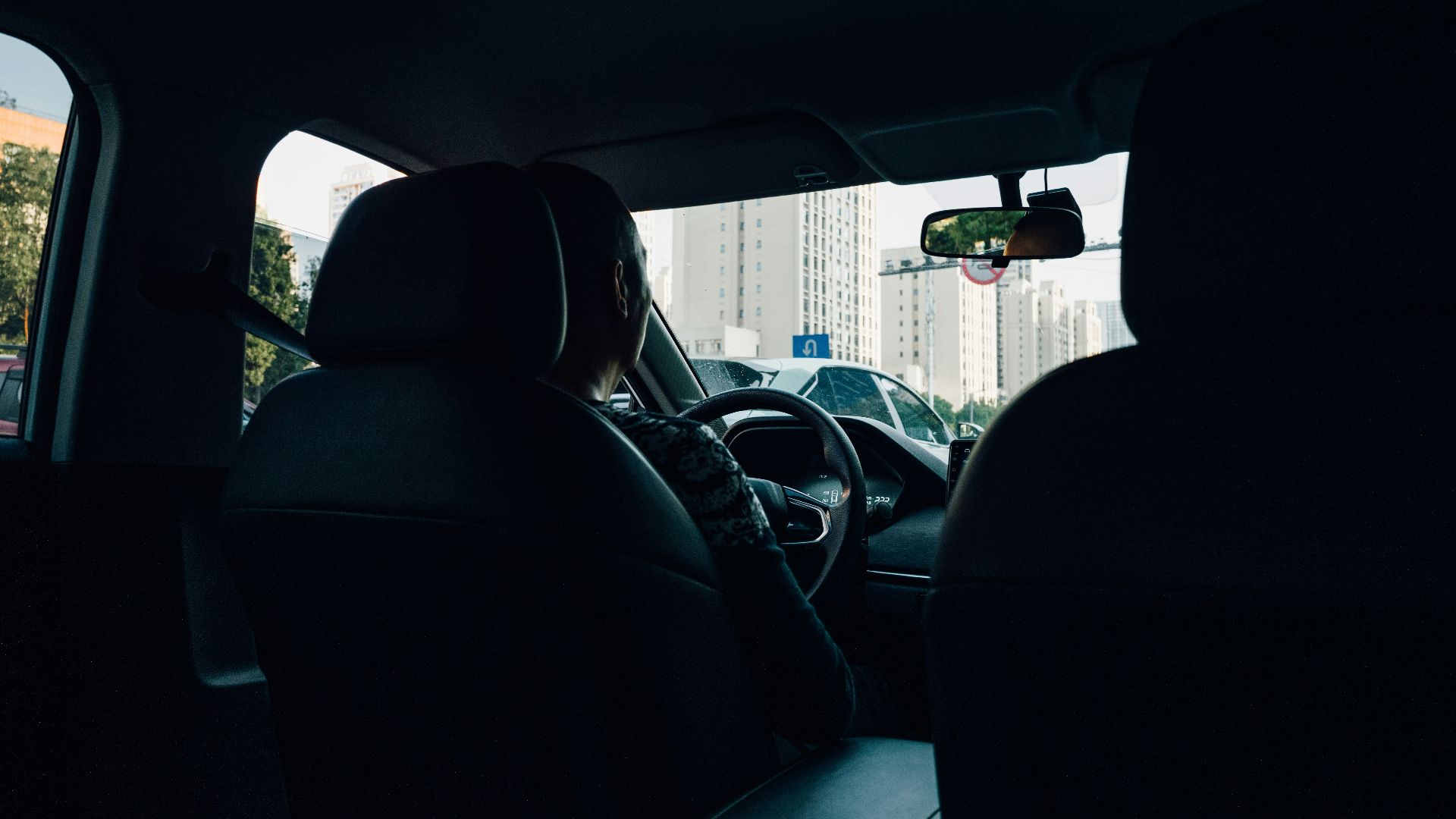 a man driving a car in the dark