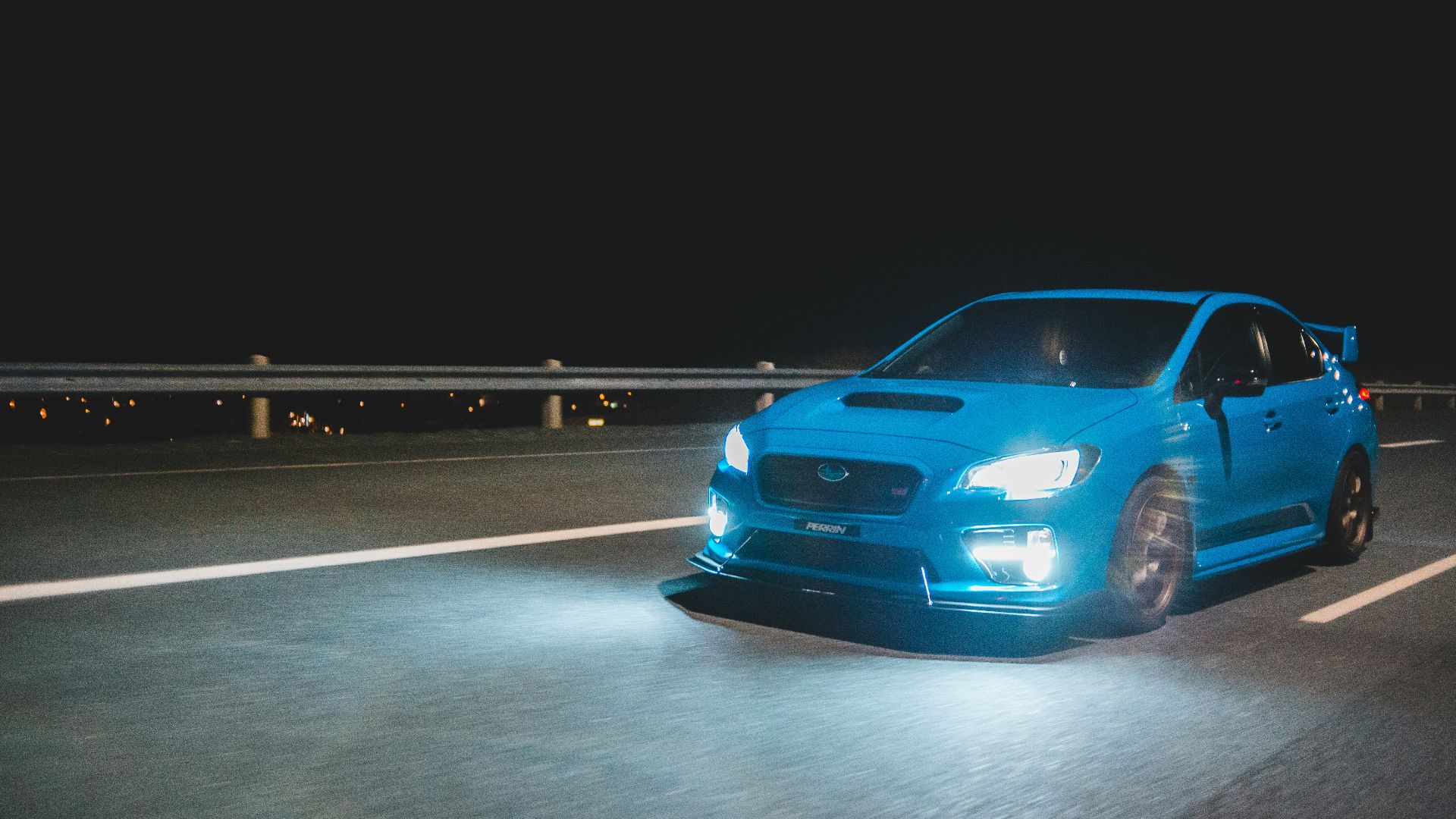 blue car on gray road during night time