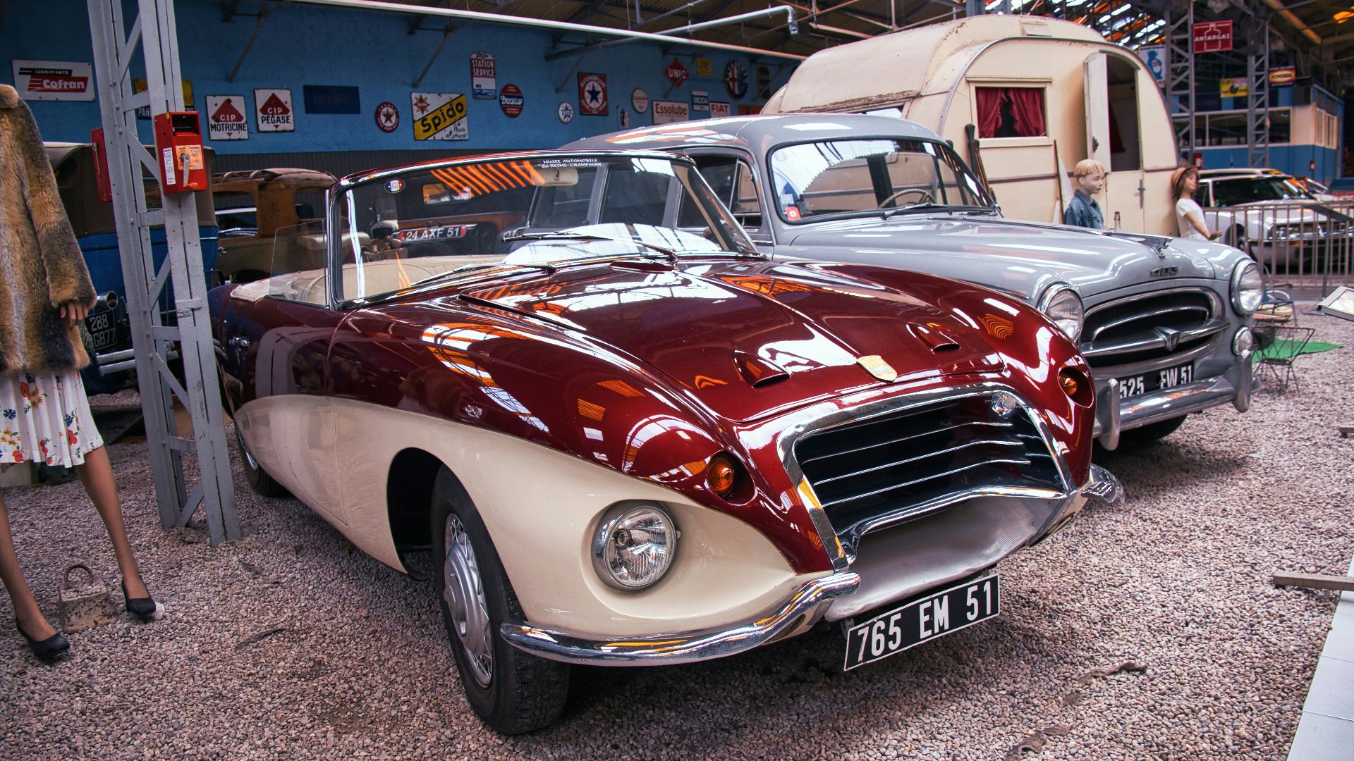 A couple of cars parked next to each other in a garage