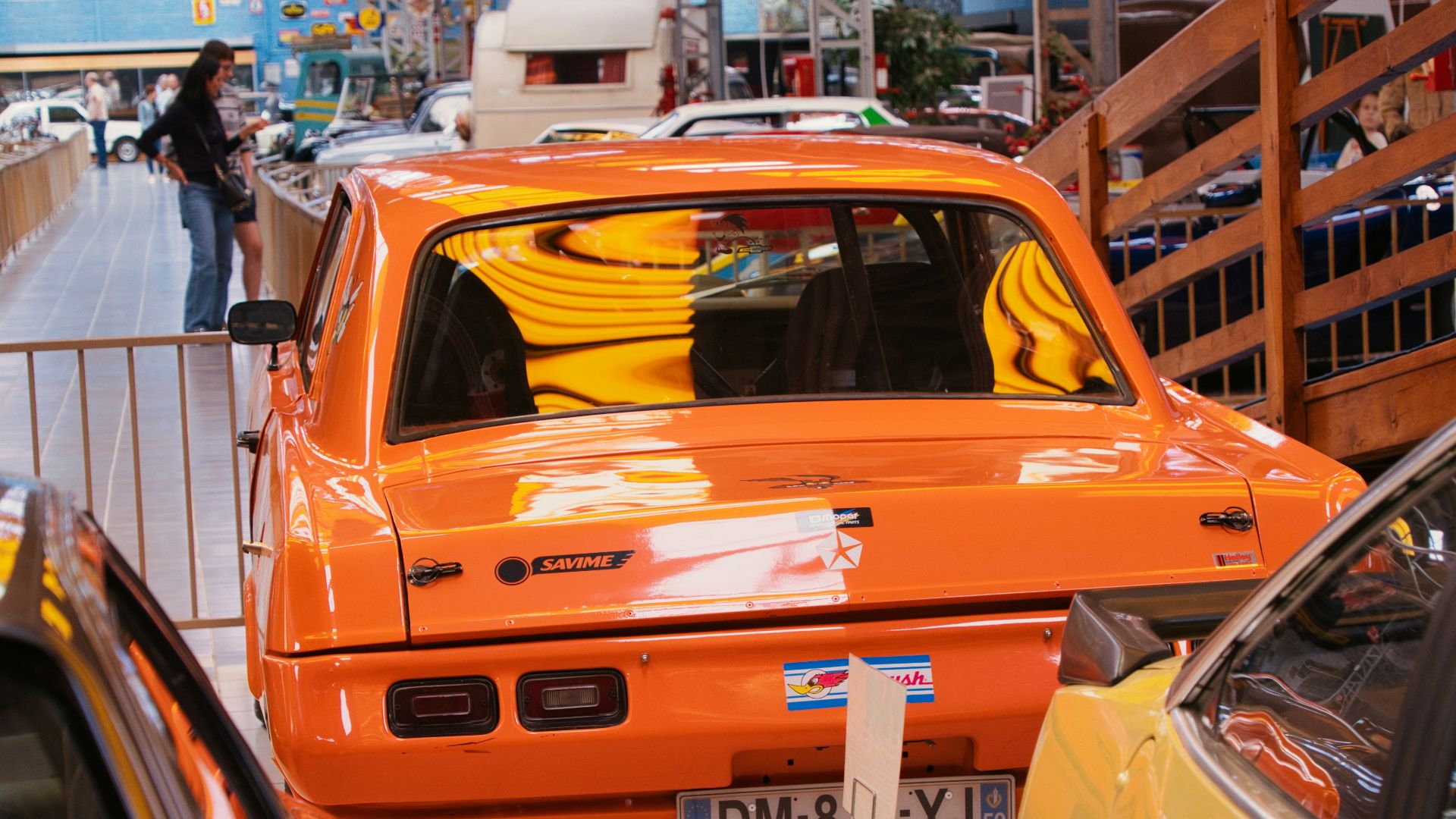 A group of cars parked inside of a garage