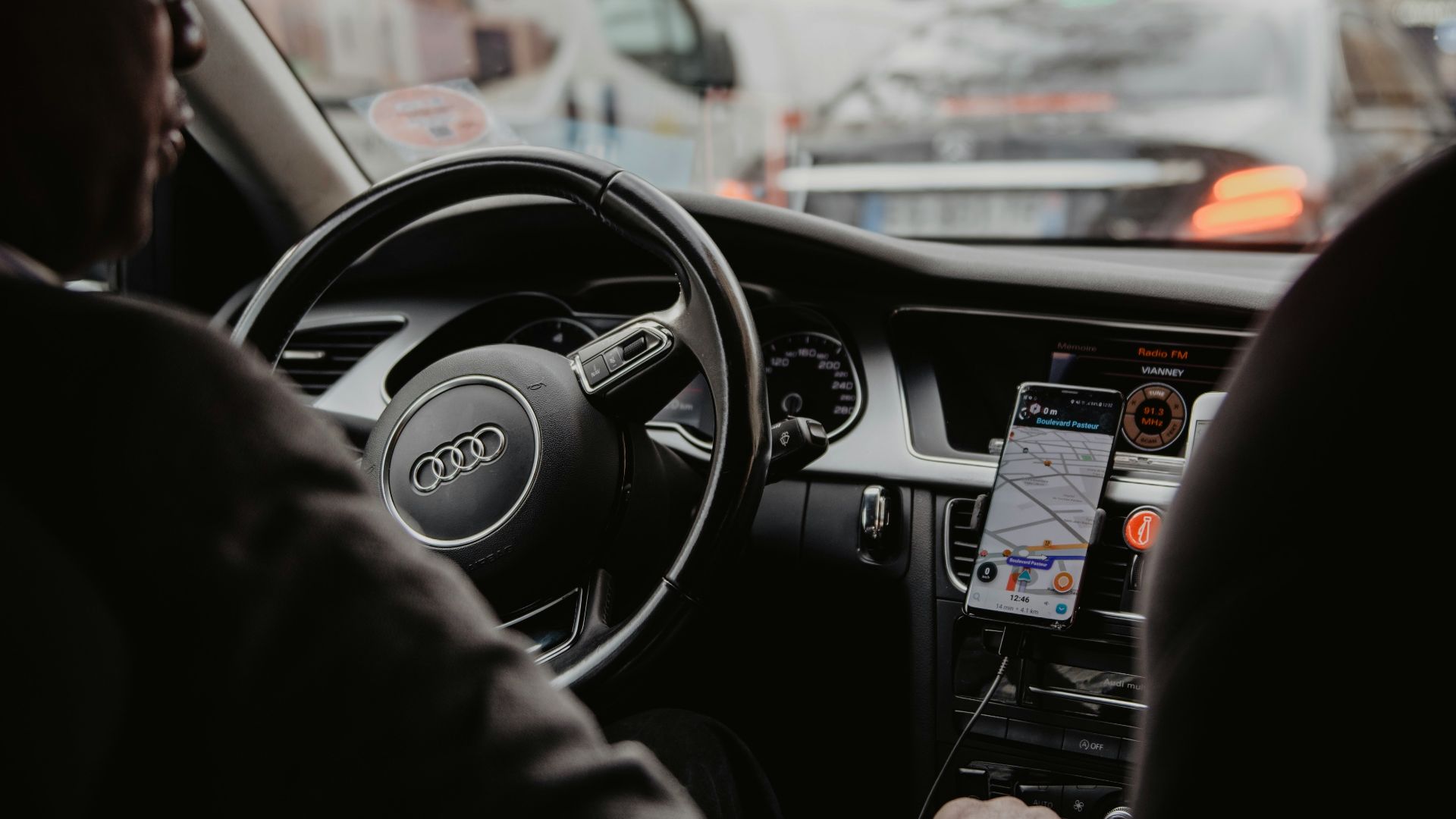 man in black jacket driving car during daytime