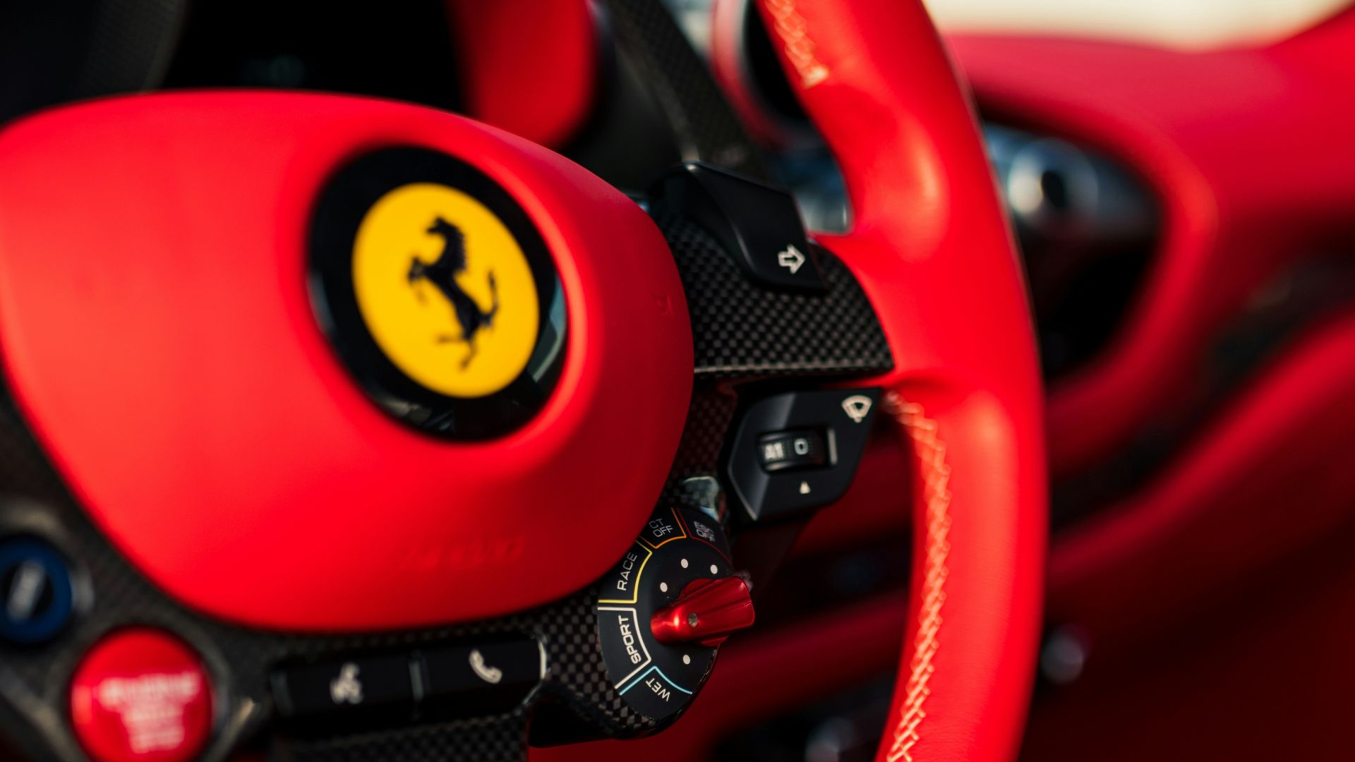 Close-up of a red ferrari steering wheel