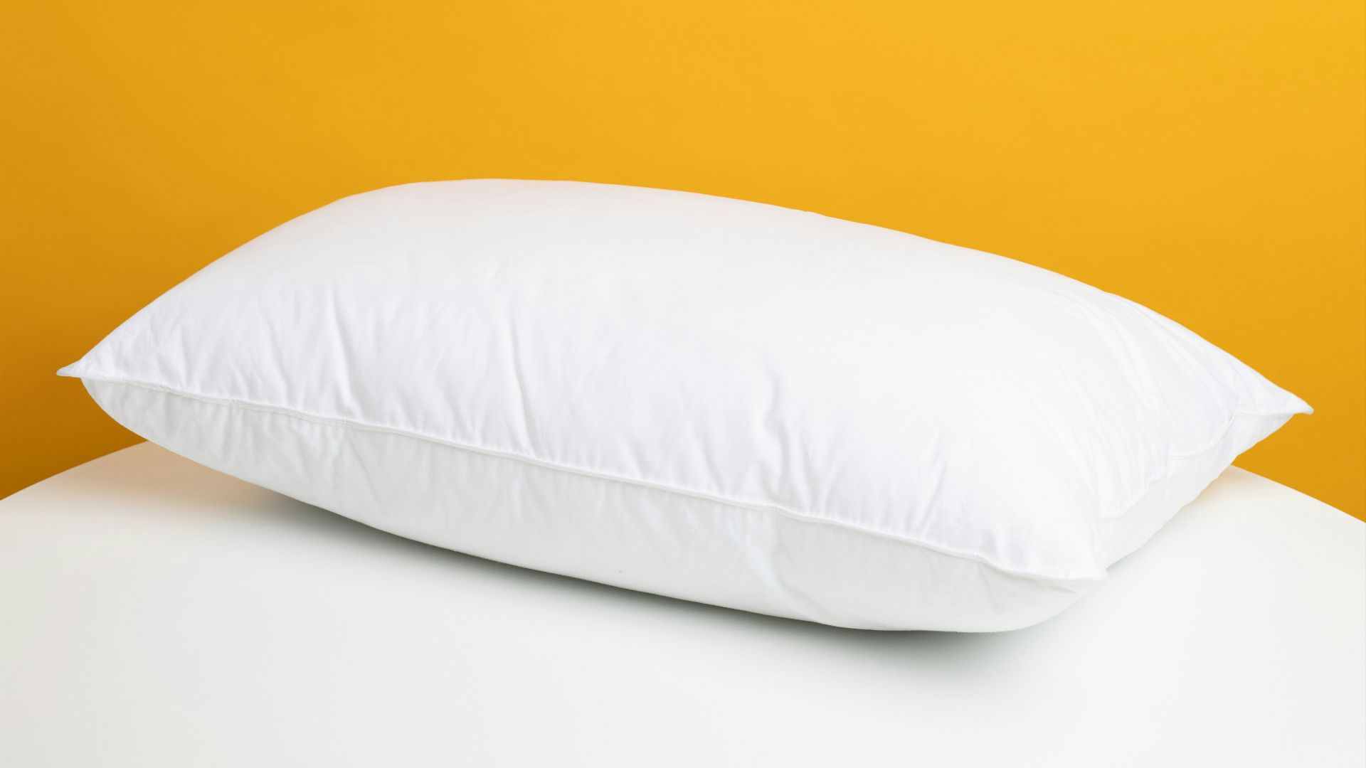 white pillow on white bed
